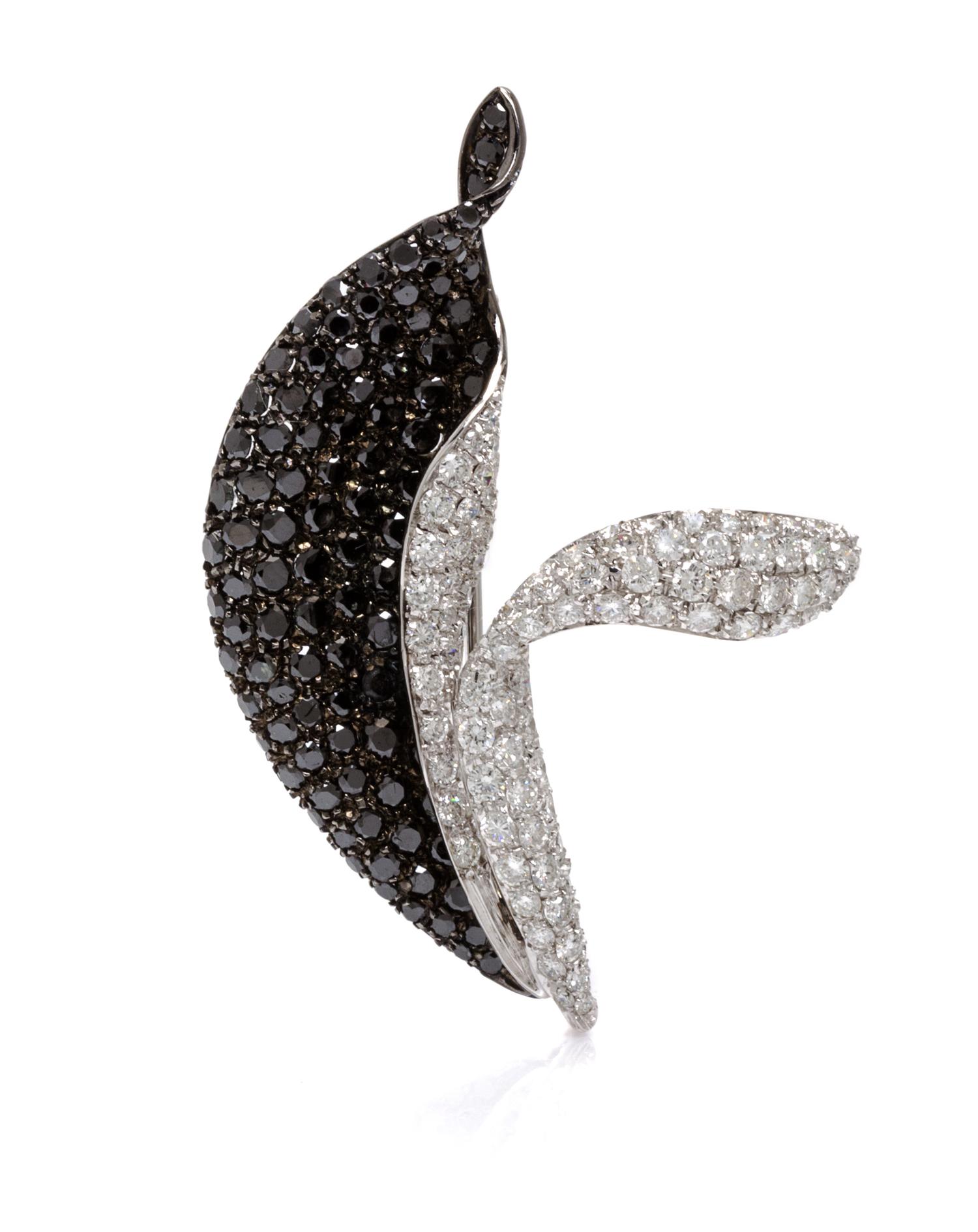 An 18 Karat White Gold, Black Diamond and Diamond Pendant/Brooch, 9.70 dwts.