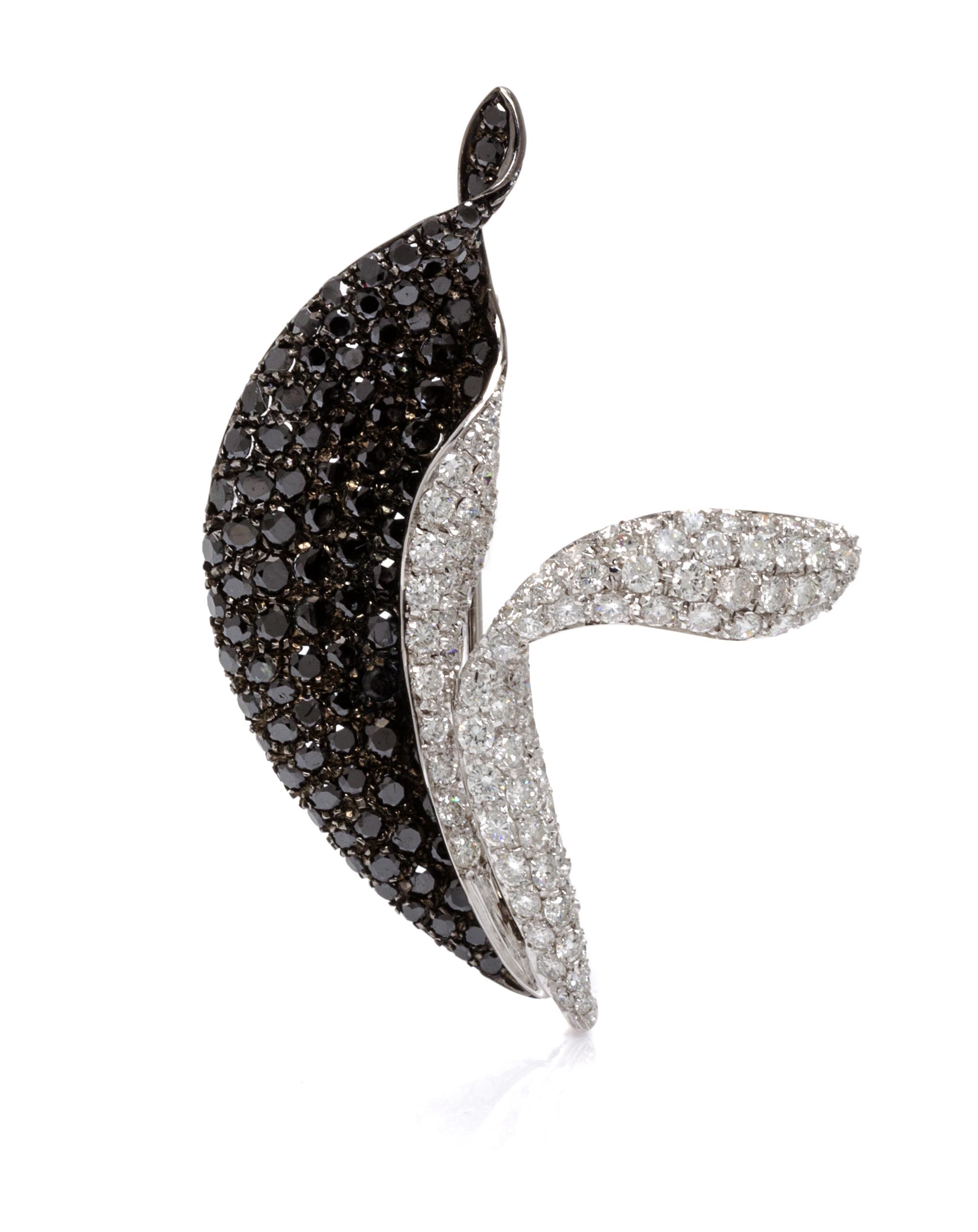 An 18 Karat White Gold, Black Diamond and Diamond Pendant/Brooch, 9.70 dwts.