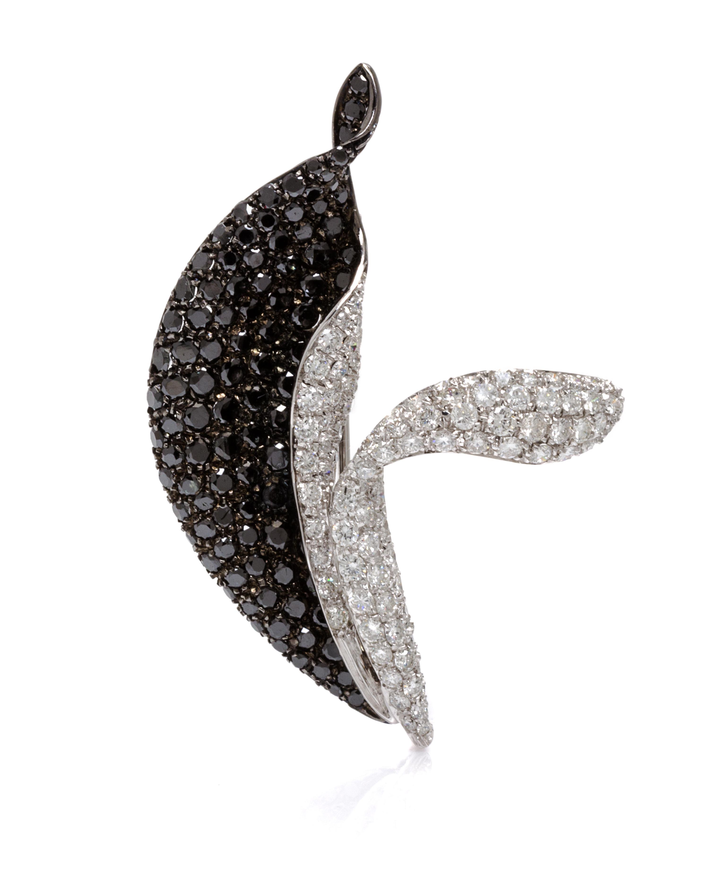 An 18 Karat White Gold, Black Diamond and Diamond Pendant/Brooch, 9.70 dwts.
