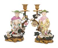 A Pair of French Porcelain, Tôle, and Gilt Bronze Figural Candlesticks