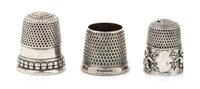 Three American Silver Thimbles, Various Makers, comprising an example with a rim worked to show putti masks, Goldsmith Stear & Co., New