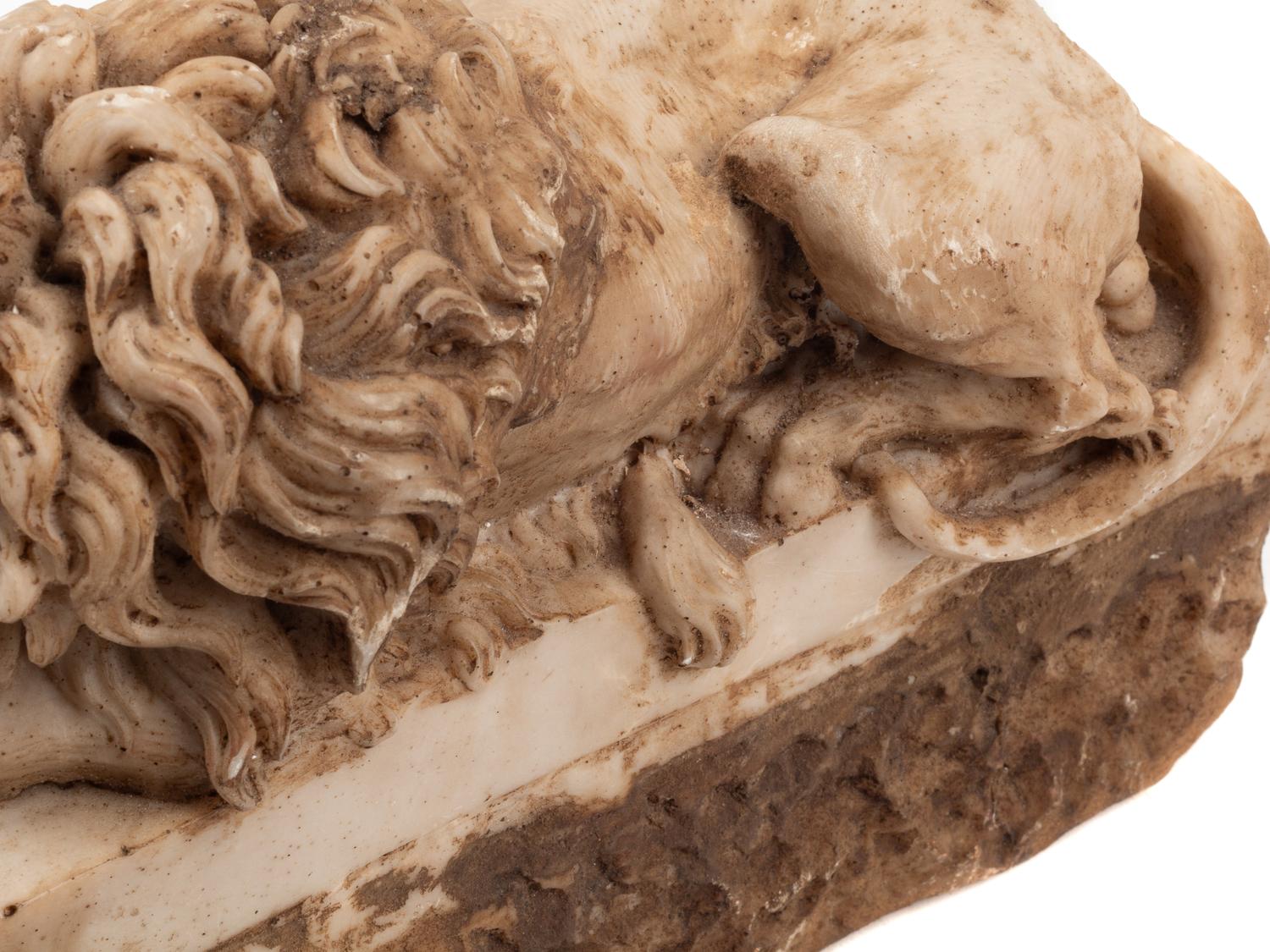 A Pair of Composition Marble Recumbent Lions