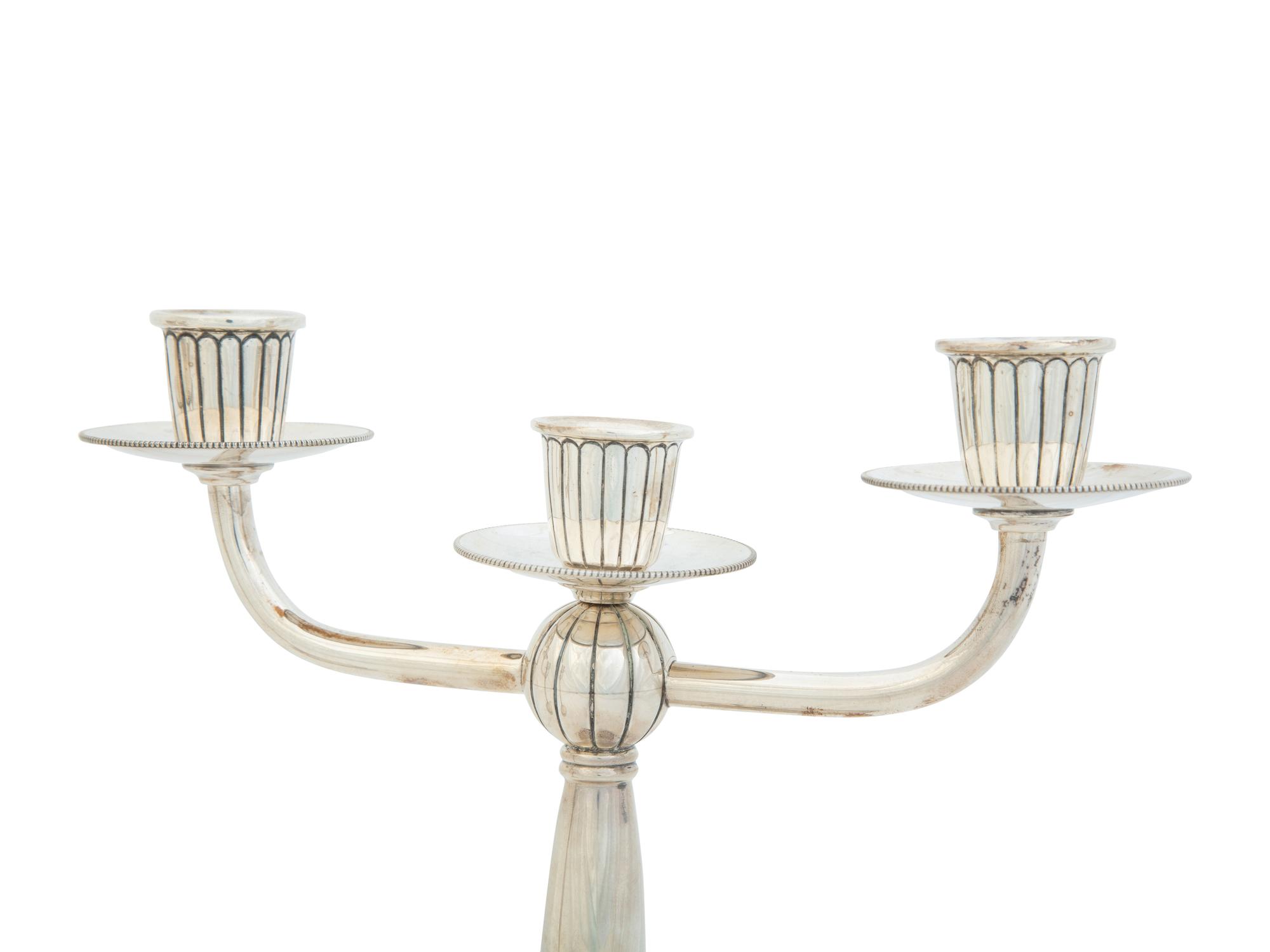 A Pair of Argentine Weighted Silver Three-Light Candelabra
