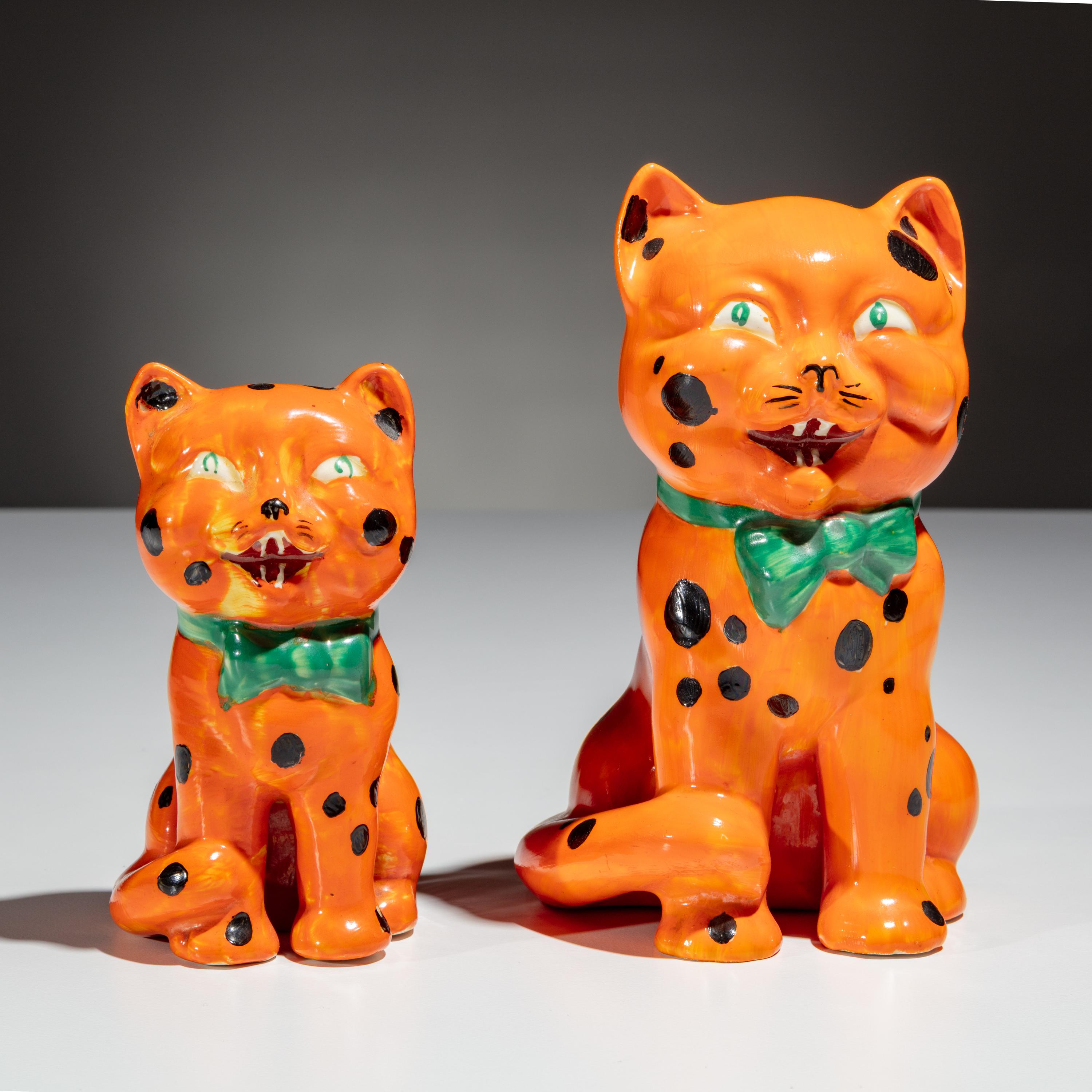 Clarice Cliff (English, 1899–1972) — Two Orange Laughing Cat Figures
