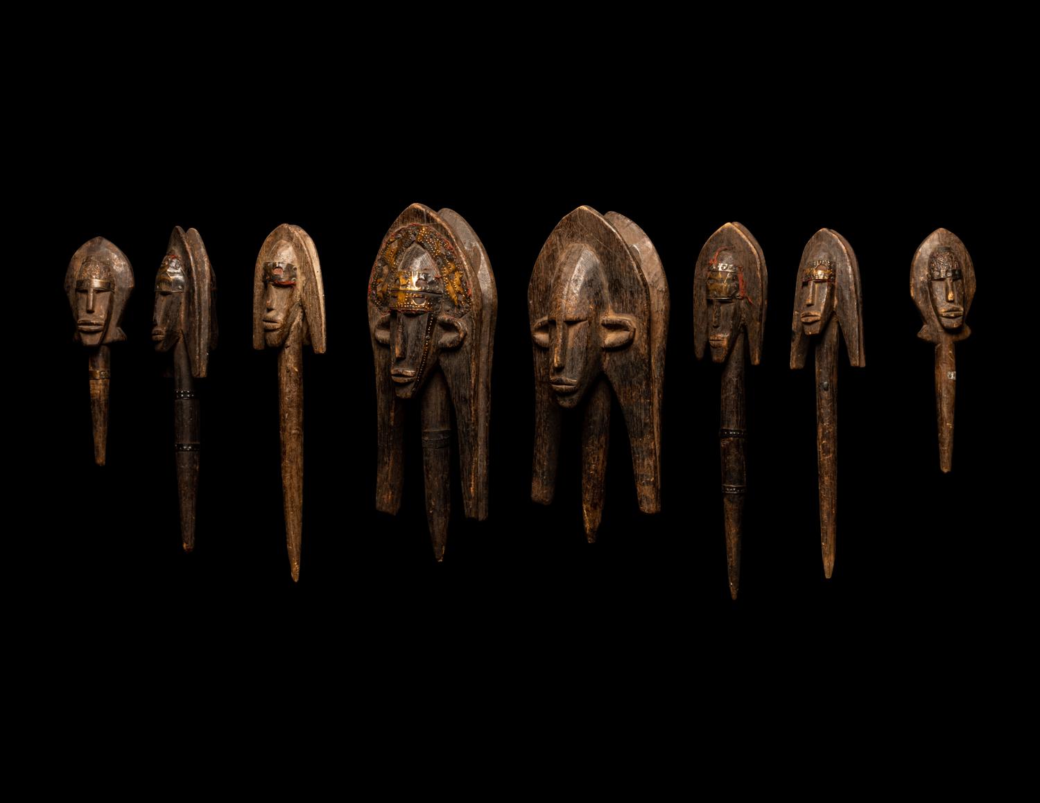 A Bamana Wood Marionette Figure with Eight Wood Puppet Heads