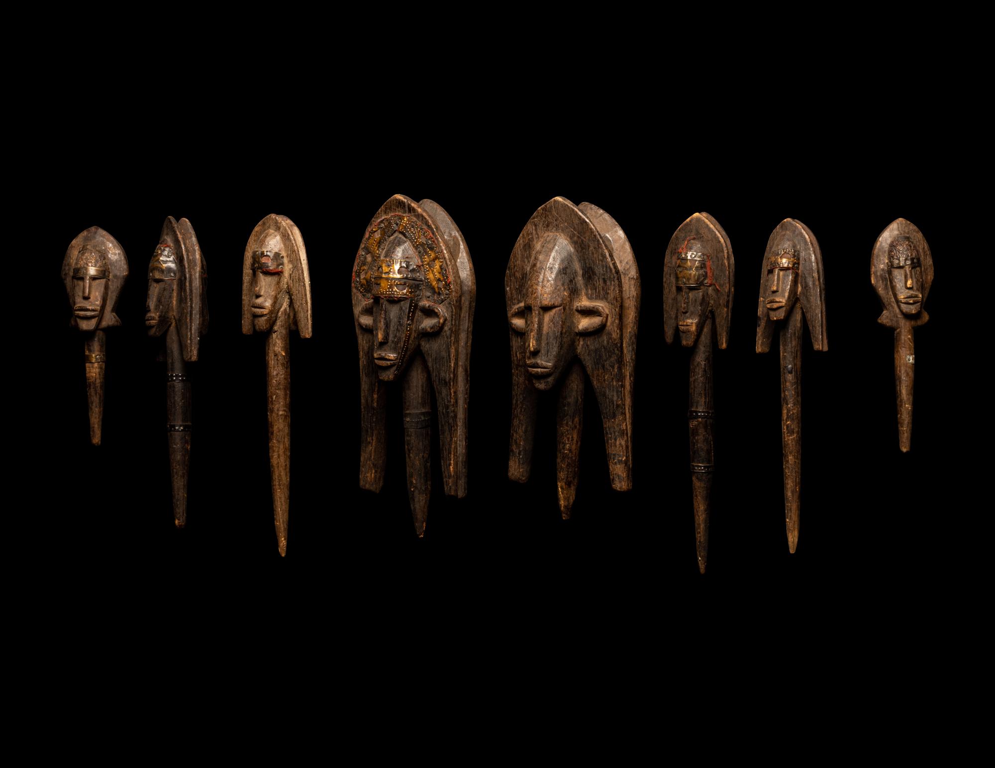 A Bamana Wood Marionette Figure with Eight Wood Puppet Heads