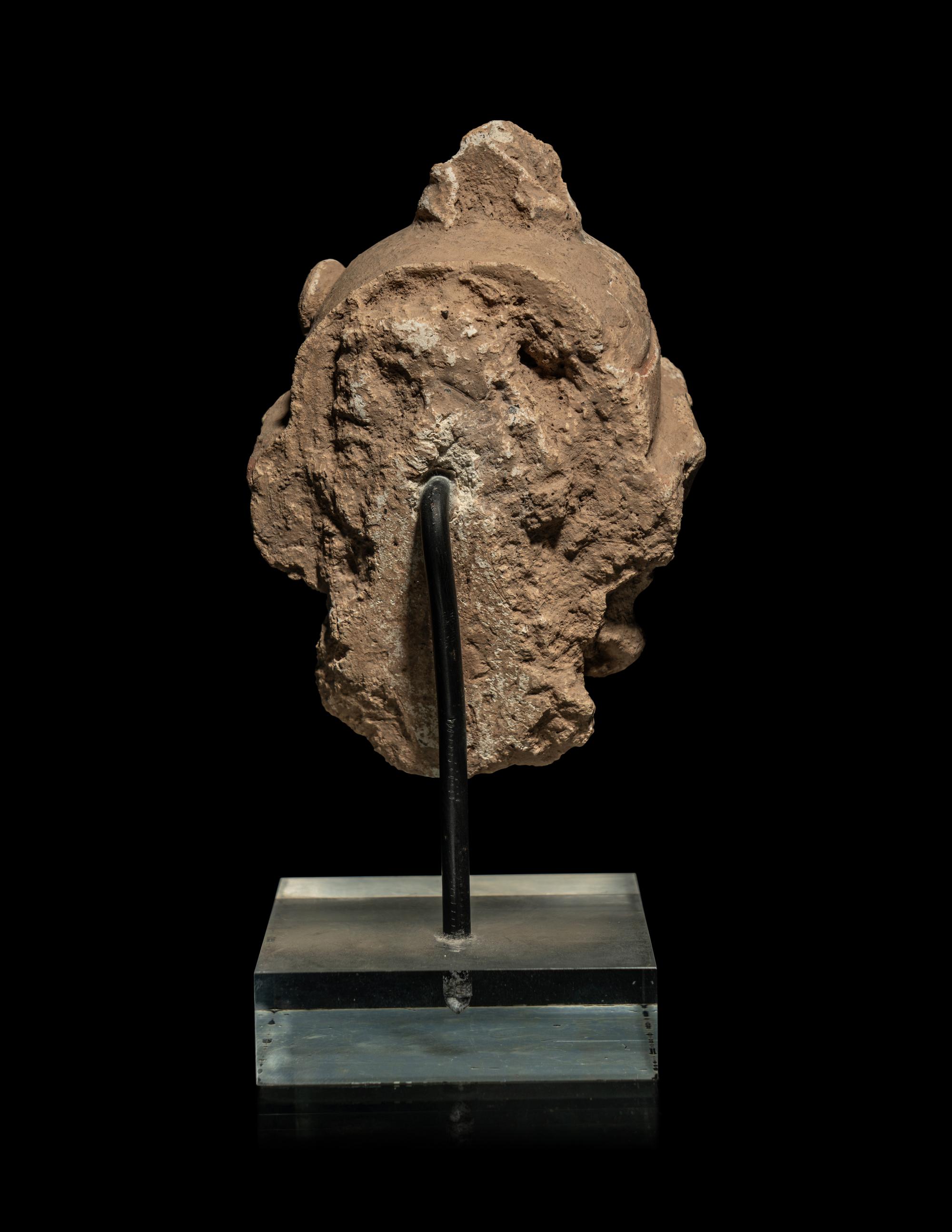 A Small Gandharan Polychromed Stucco Head of a Bodhisattva