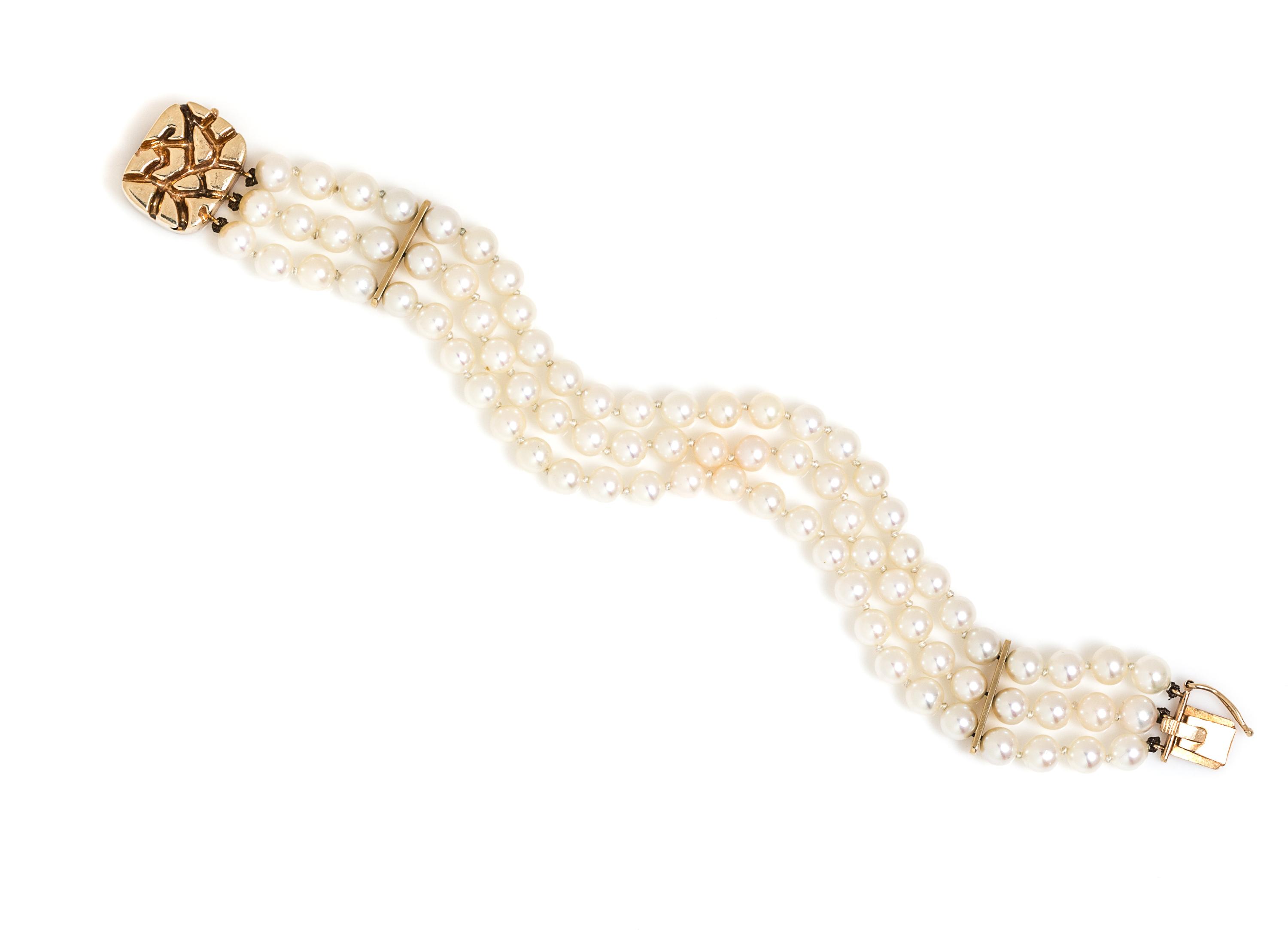 A 14 Karat Yellow Gold and Multistrand Cultured Pearl Bracelet,