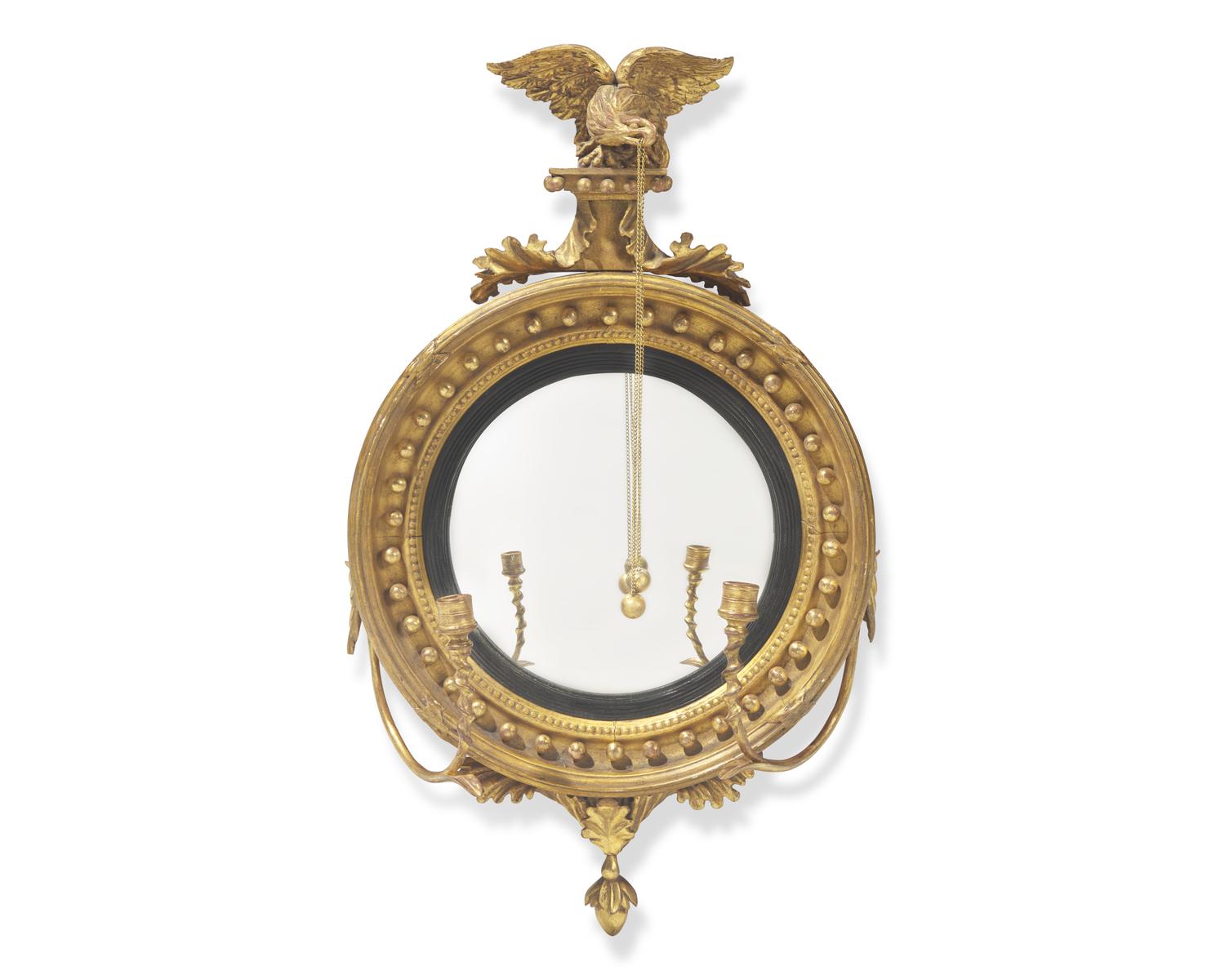 A Classical carved giltwood girandole bull's eye mirror, 19th century
