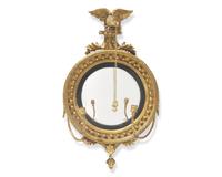 A Classical carved giltwood girandole bull's eye mirror, 19th century