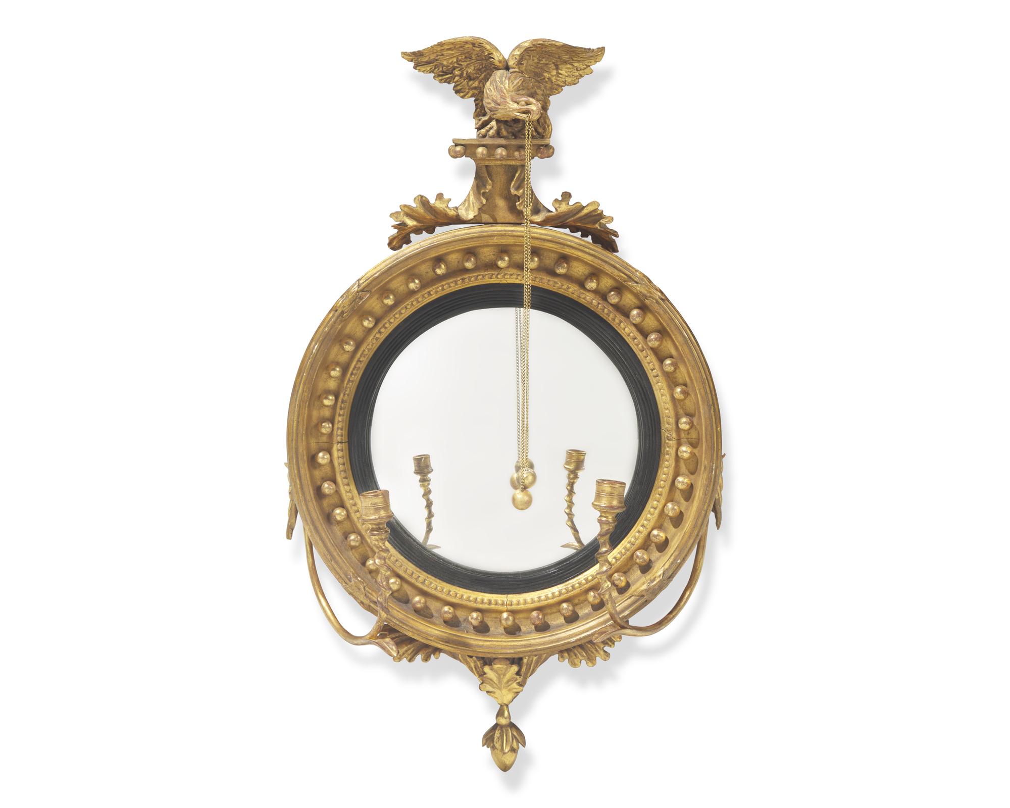 A Classical carved giltwood girandole bull's eye mirror, 19th century