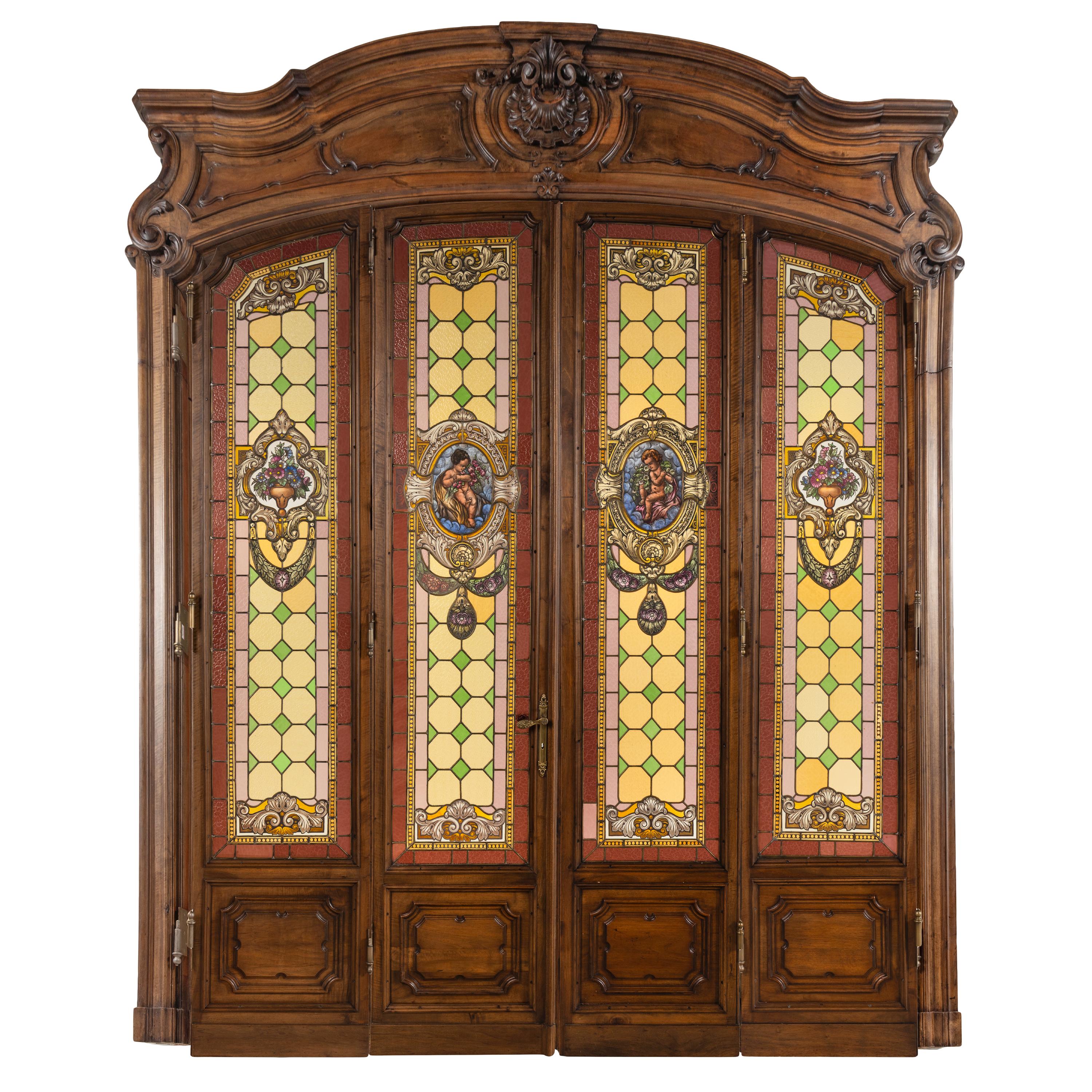 A French Carved Walnut and Leaded Glass Double-Door Portal