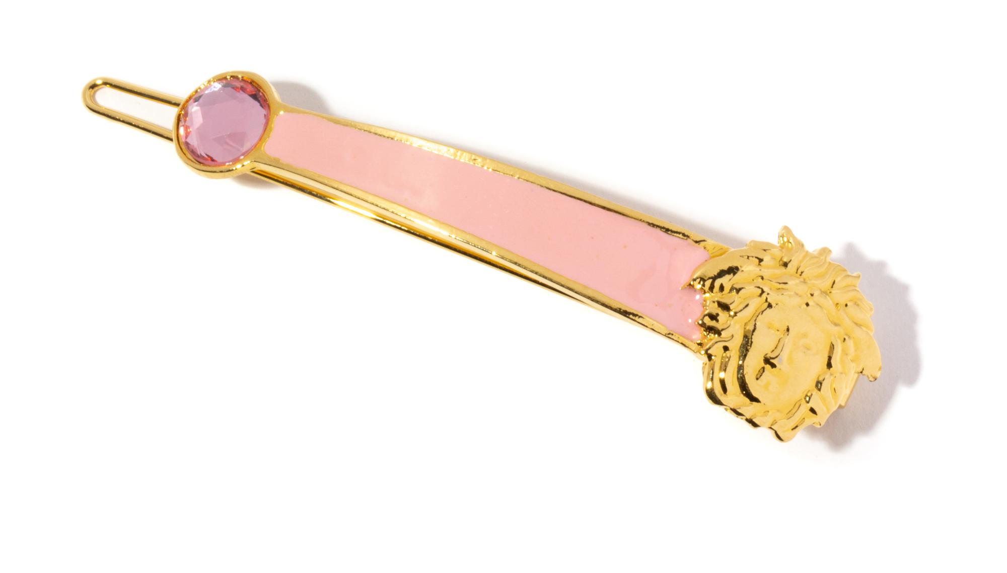A Gianni Versace Pink Enamel and Medusa Hair Clip, 3.25" x .75".