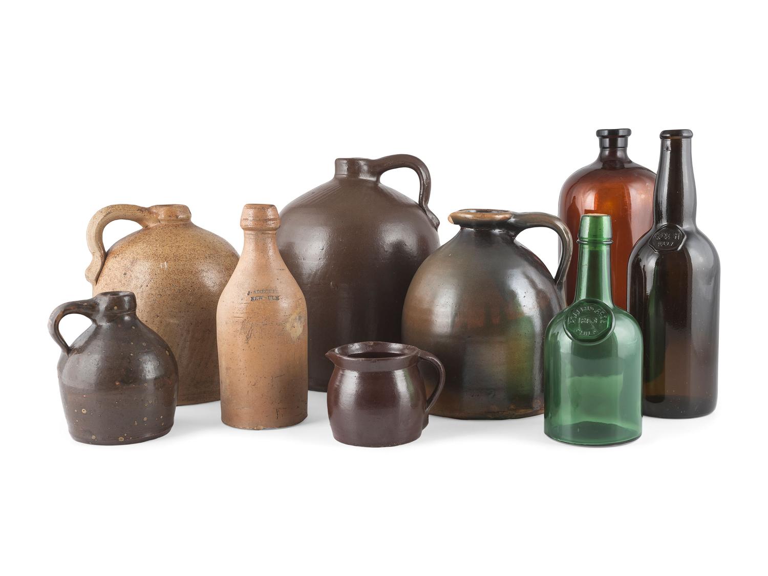 A Group of Stoneware Jugs and Glass Bottles