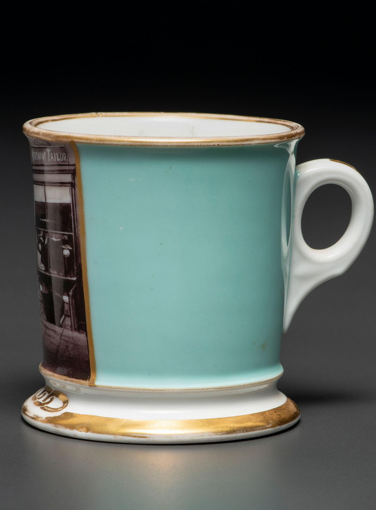 A Paint Enhanced Photographic Transfer Porcelain Occupational Shaving Mug Depicting a Tailor's Shop
