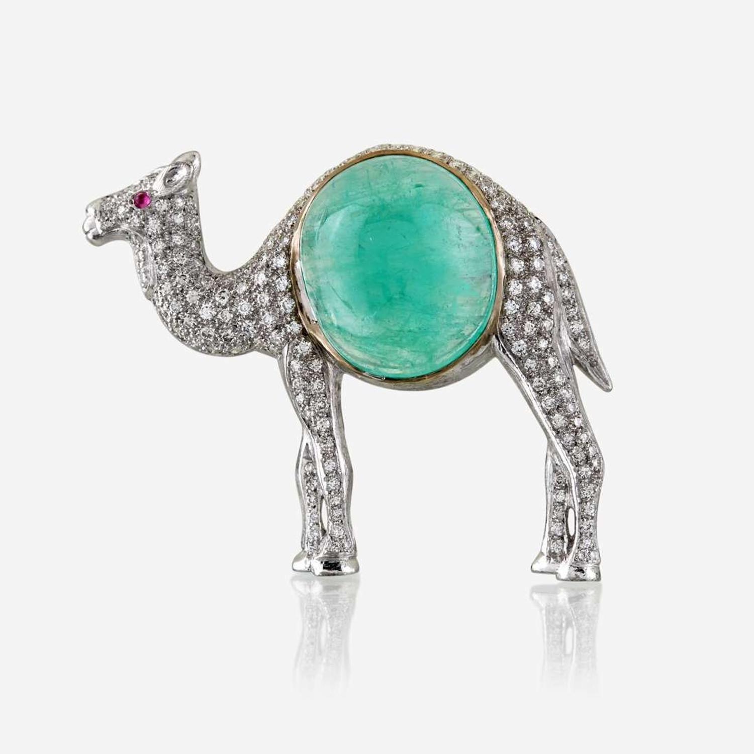 An emerald, diamond, and eighteen karat white gold brooch