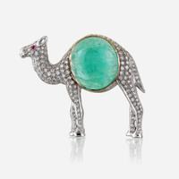 An emerald, diamond, and eighteen karat white gold brooch