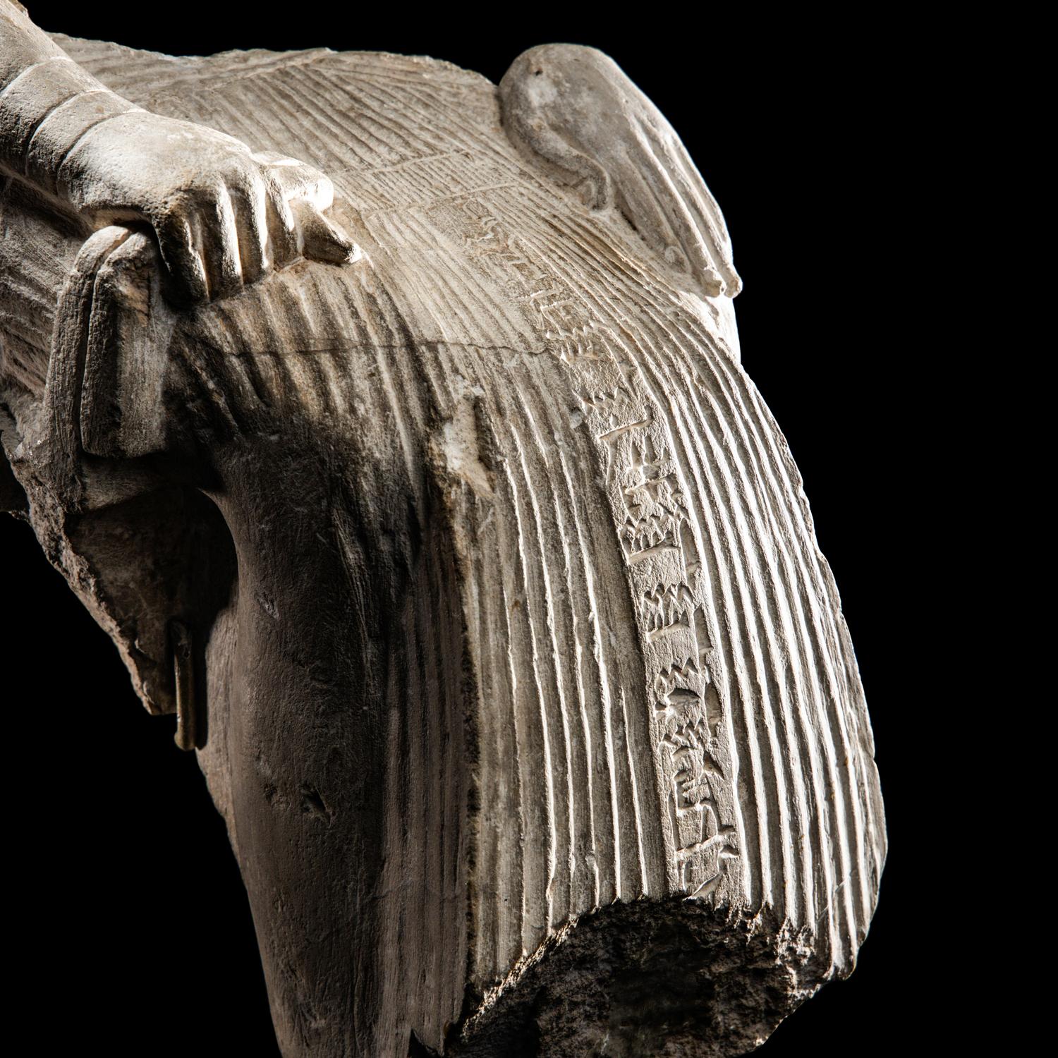 An Egyptian Limestone Fragment of a Seated Scribe