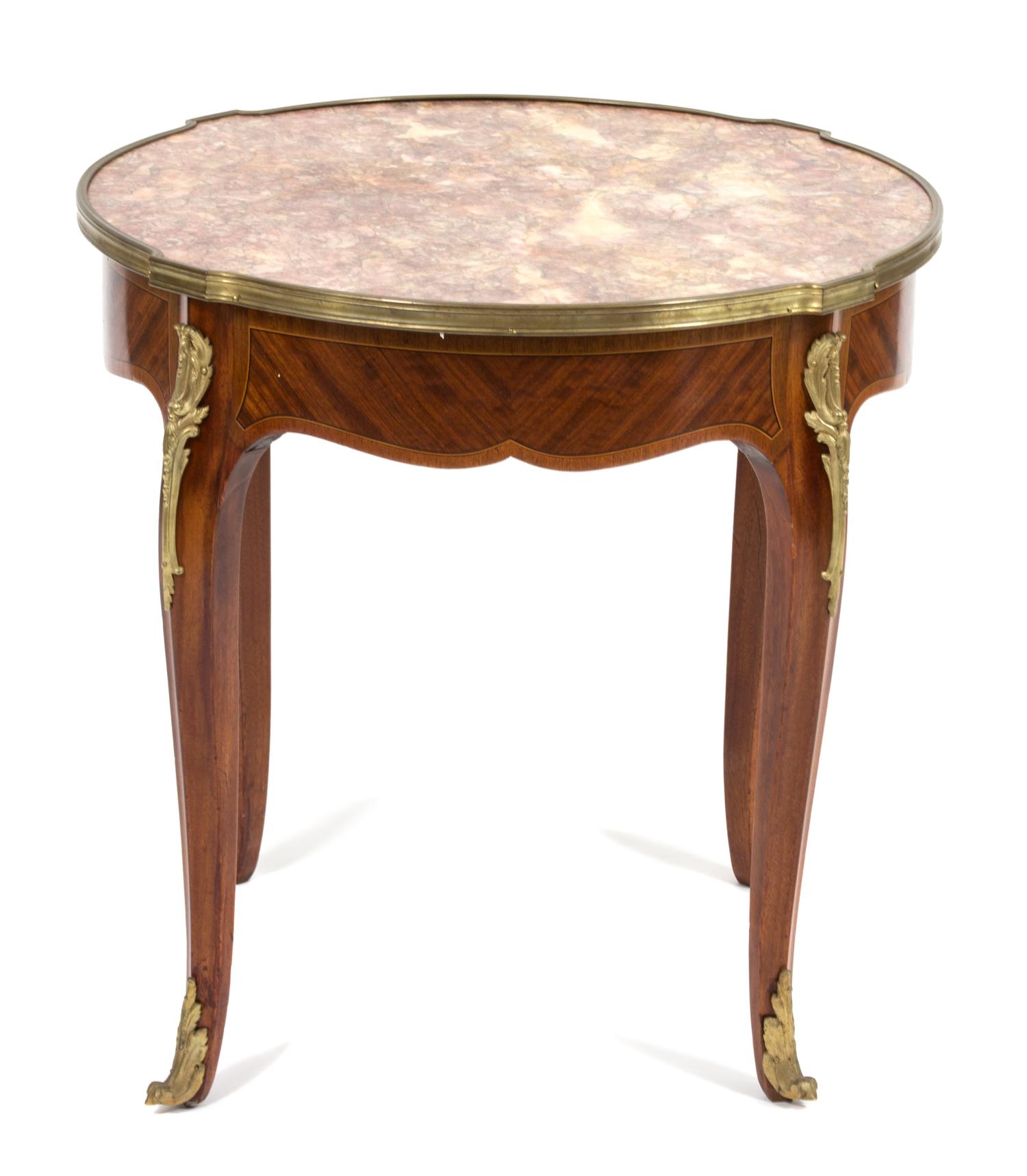 A Louis XV Style Marble Top Gilt Metal Mounted Table Height 22 1/2 x diameter 23 1/4 inches. — 19TH CENTURY