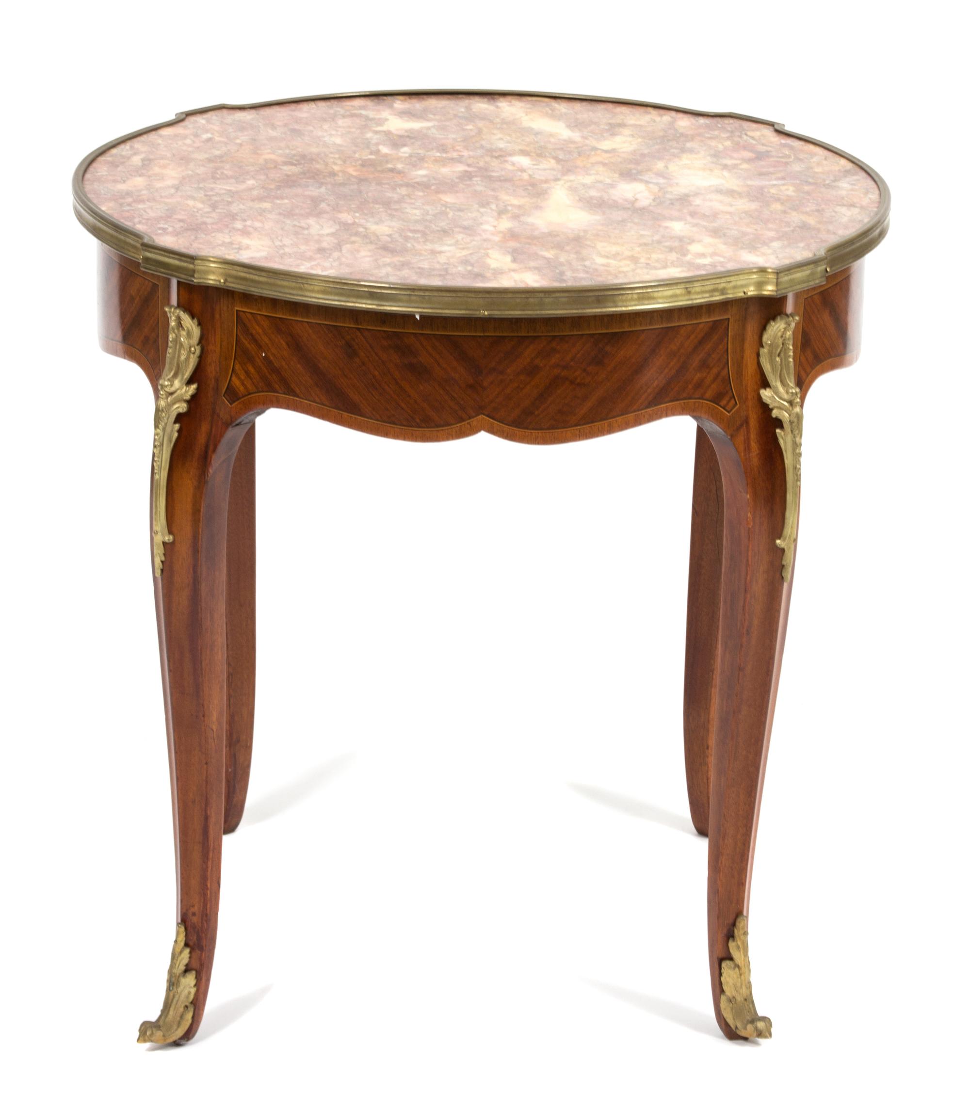 A Louis XV Style Marble Top Gilt Metal Mounted Table Height 22 1/2 x diameter 23 1/4 inches. — 19TH CENTURY