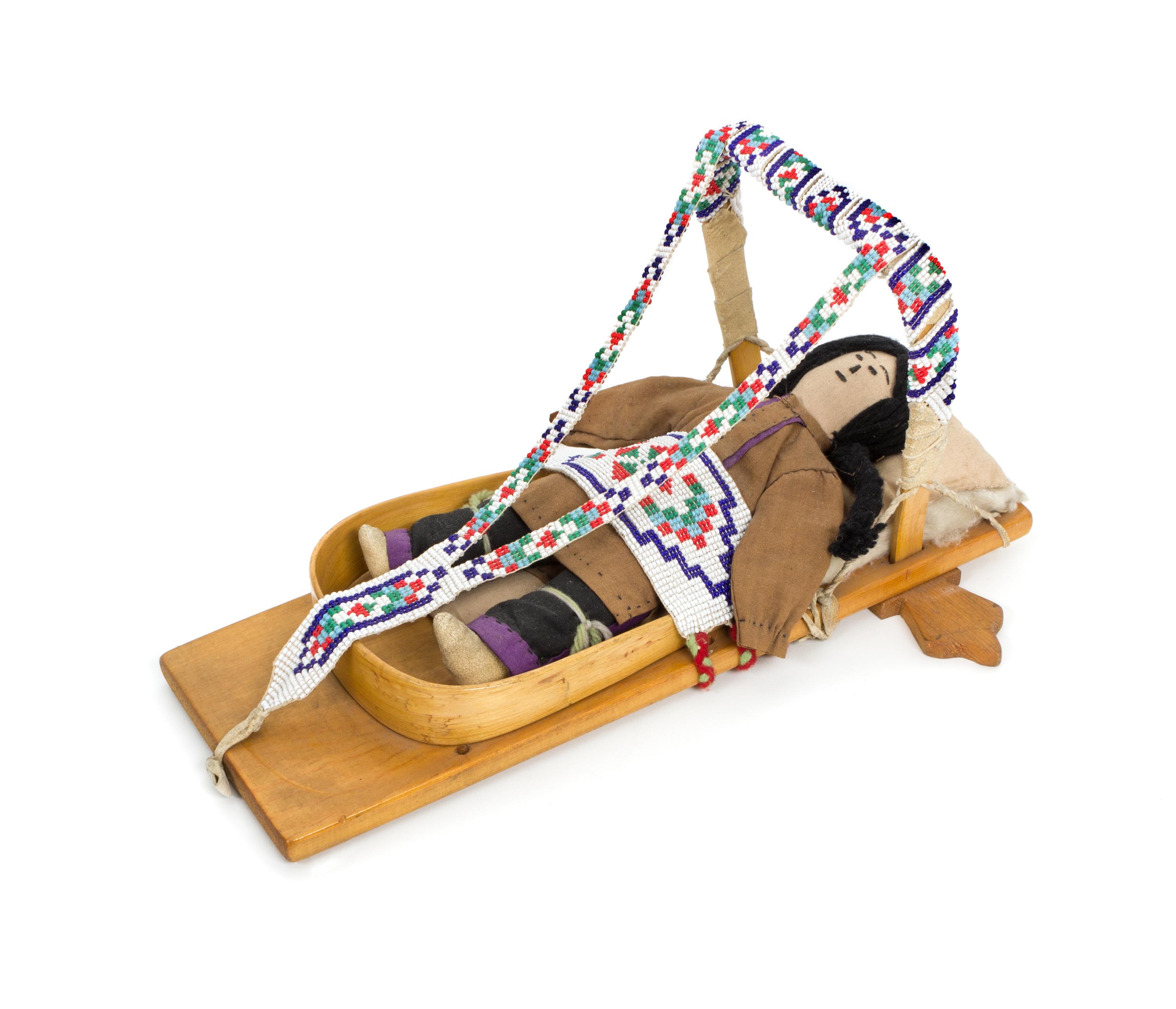 An Ojibwa/ Chippewa Beaded Doll Cradleboard Length 12 x width 8 1/4 inches.