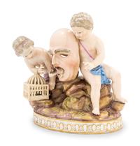 A Meissen Porcelain Group of Two Putti with a Theater Mask, Dog and Birdcage