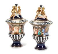 A Pair of Continental Porcelain Covered Urns Height overall 35 inches.