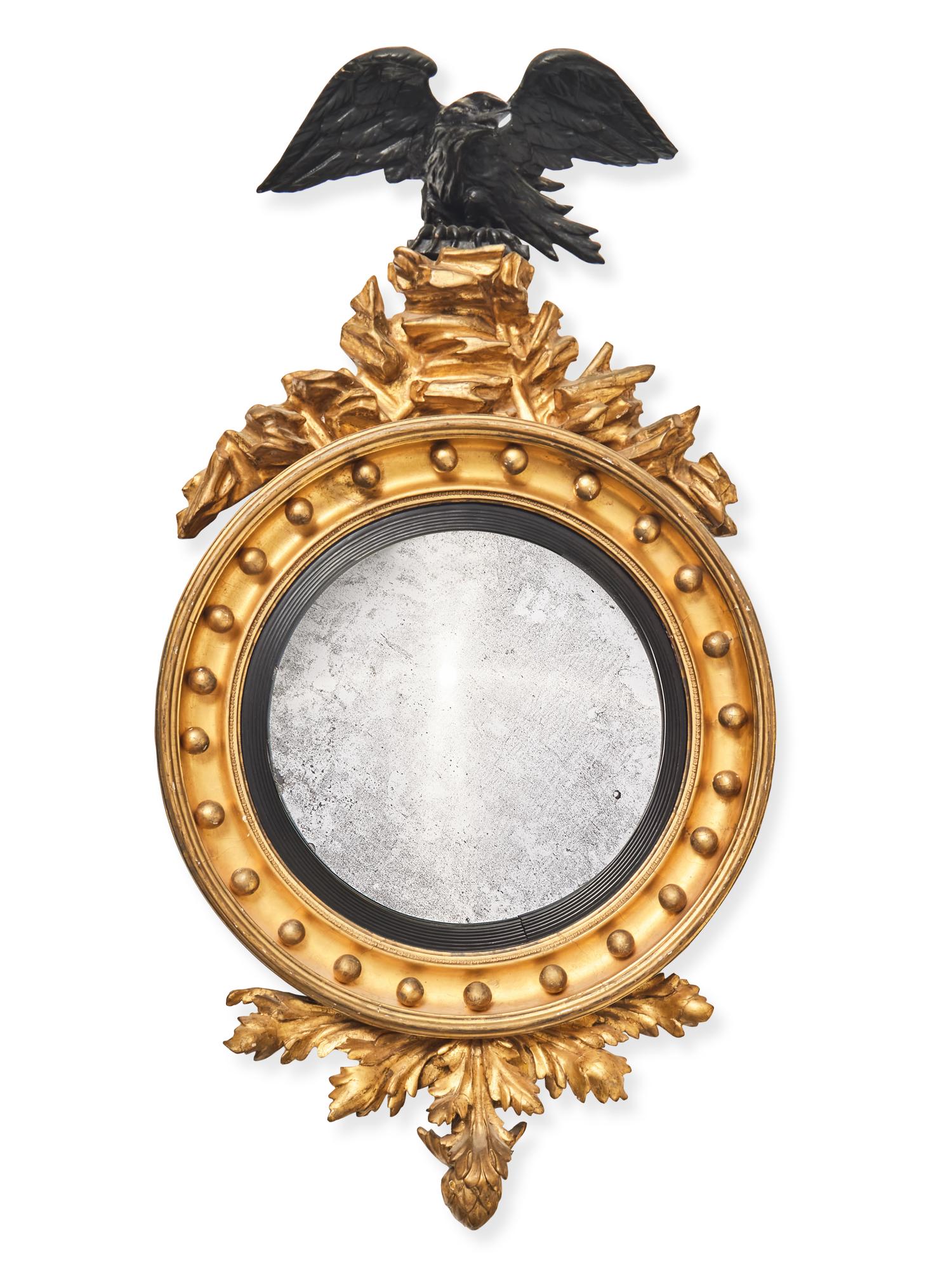 A Regency Giltwood and Part Ebonized Bull's Eye Mirror