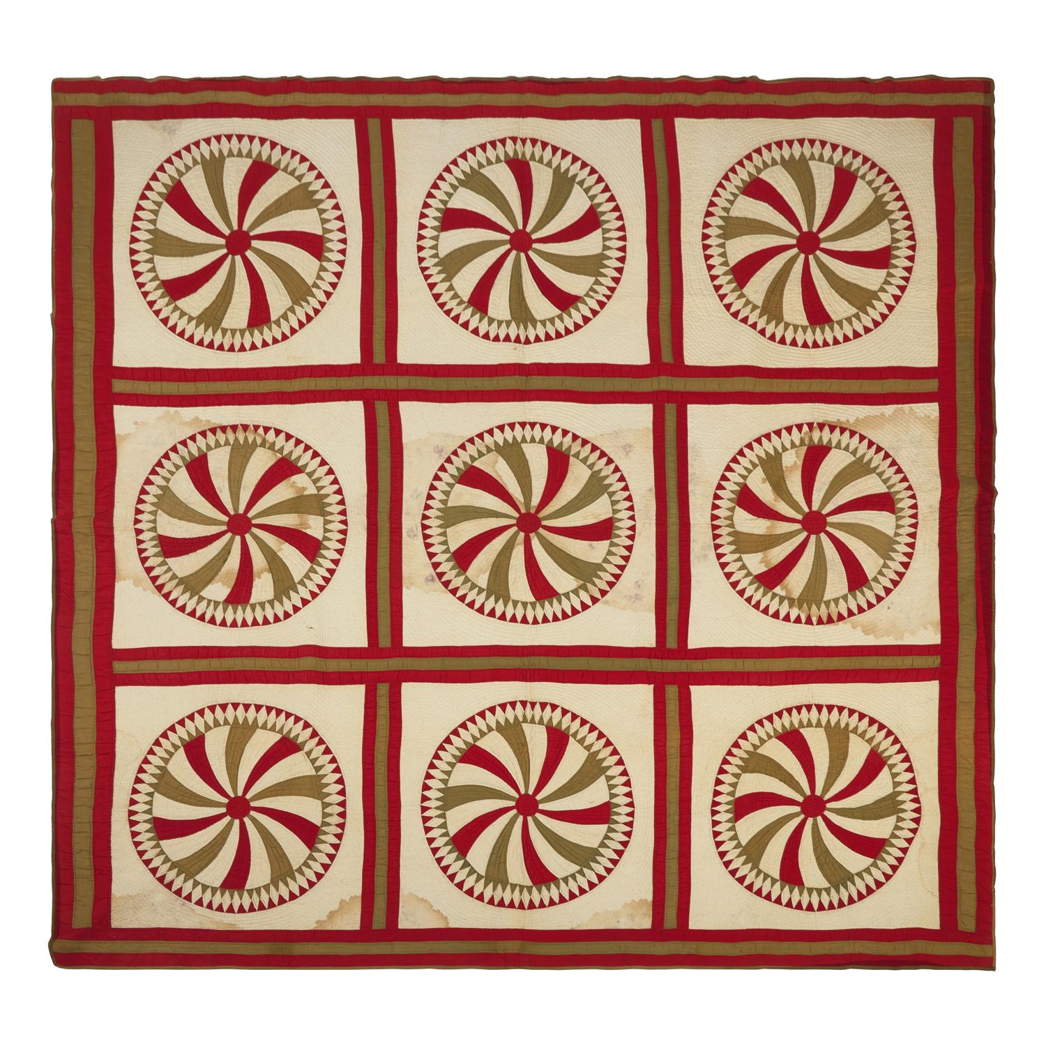 A Pieced Cotton Red and Gold Pinwheel Quilt