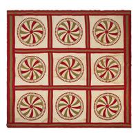 A Pieced Cotton Red and Gold Pinwheel Quilt