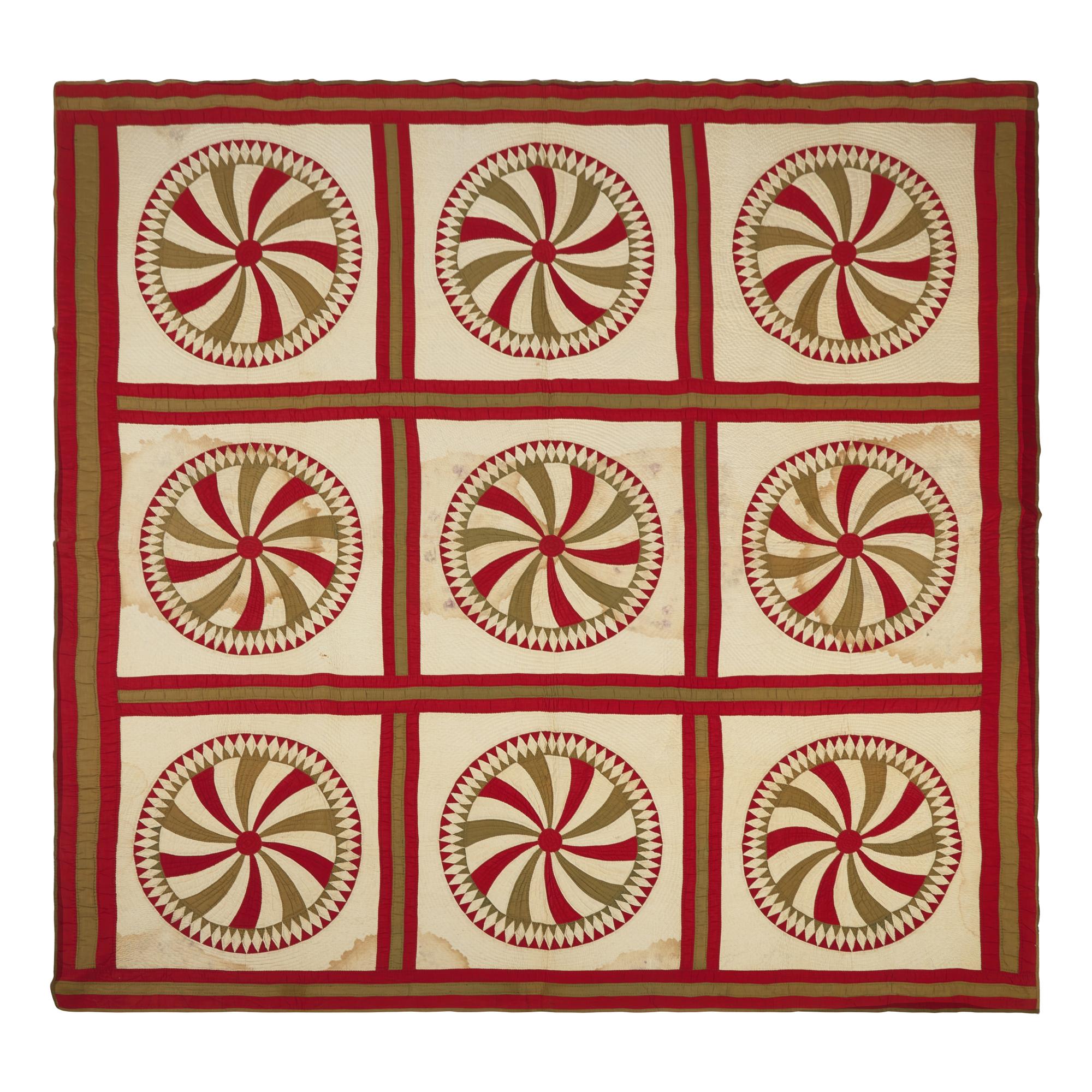A Pieced Cotton Red and Gold Pinwheel Quilt