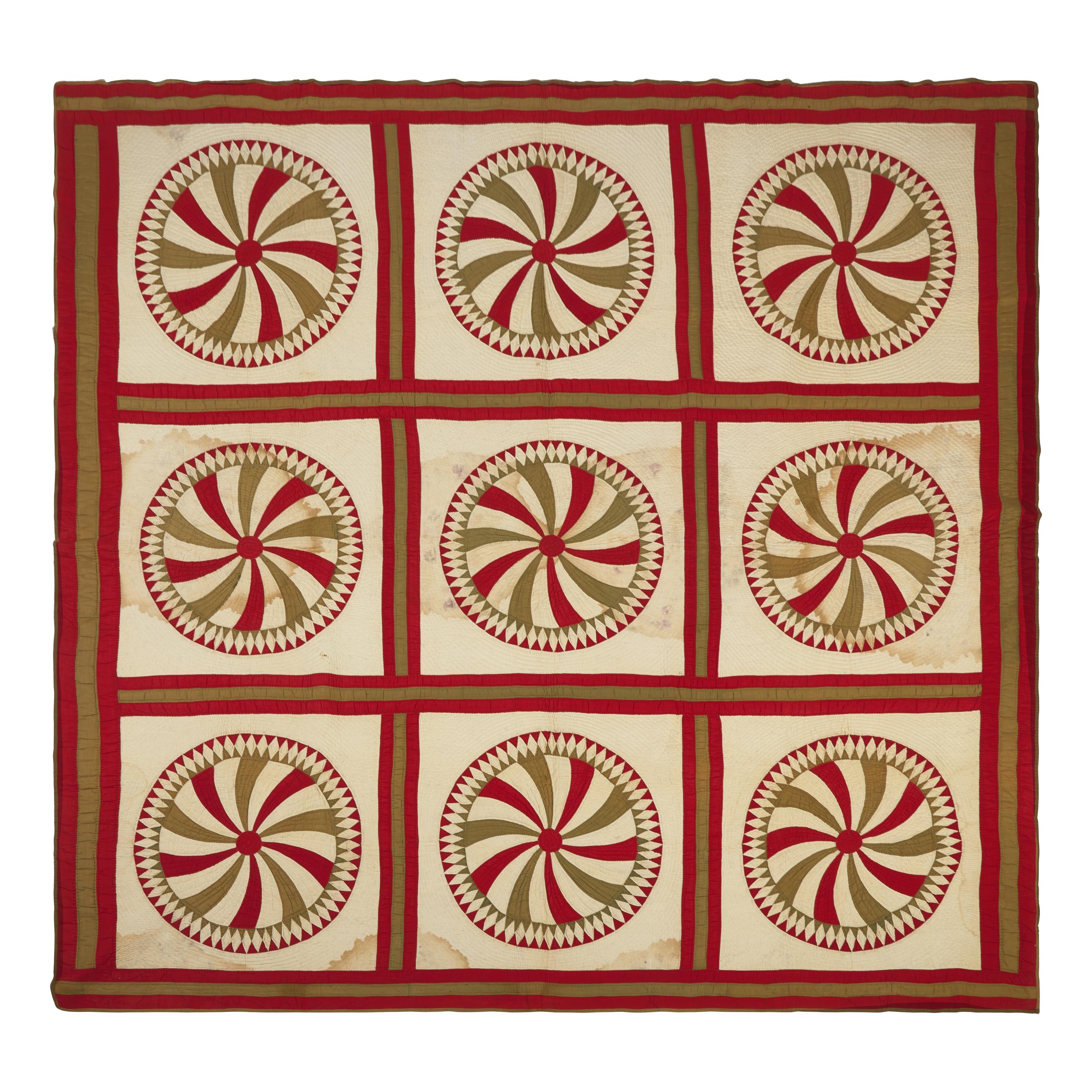 A Pieced Cotton Red and Gold Pinwheel Quilt