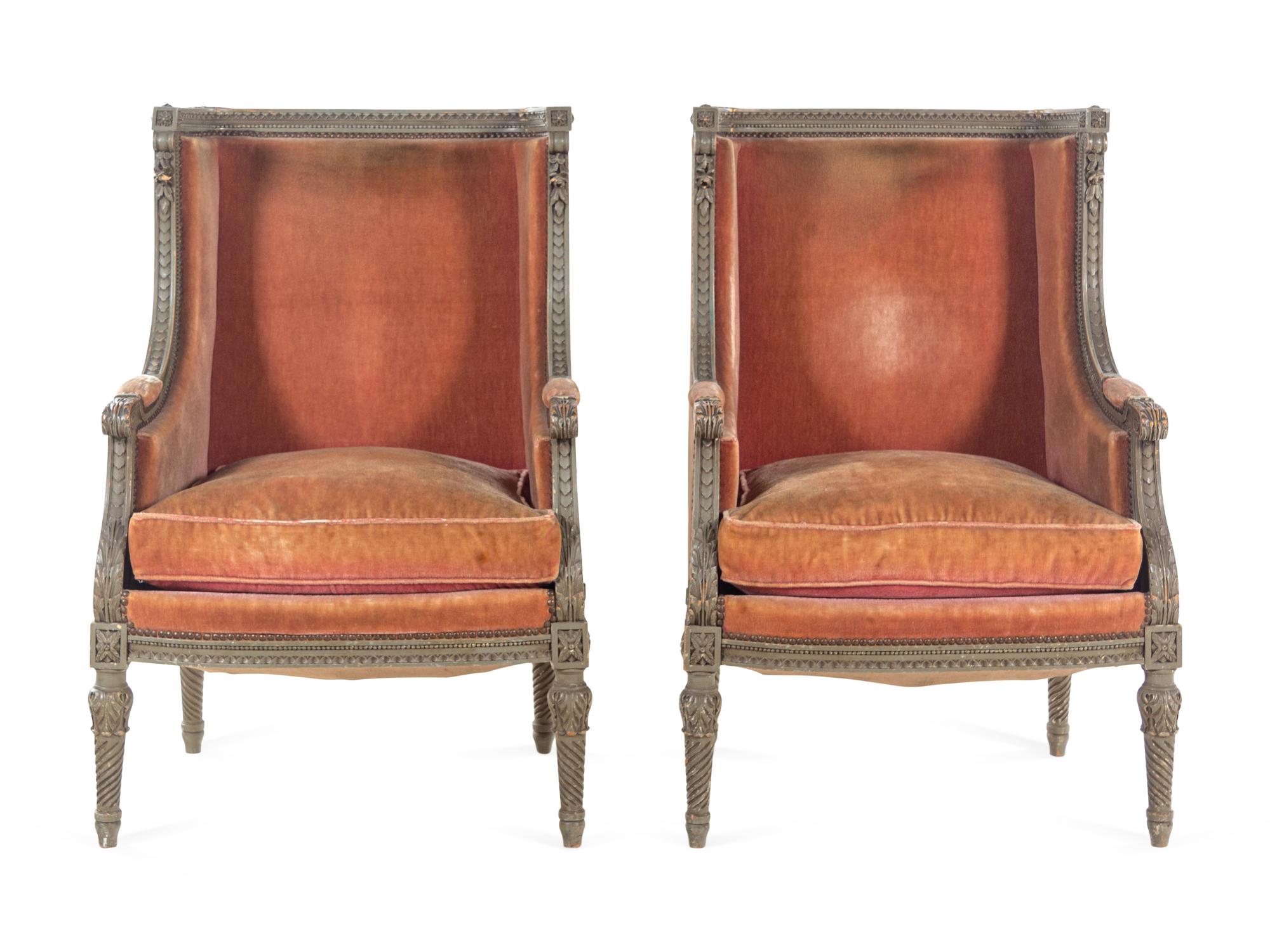 A Pair of Louis XVI Carved and Painted Walnut Bergères à L'Oreilles