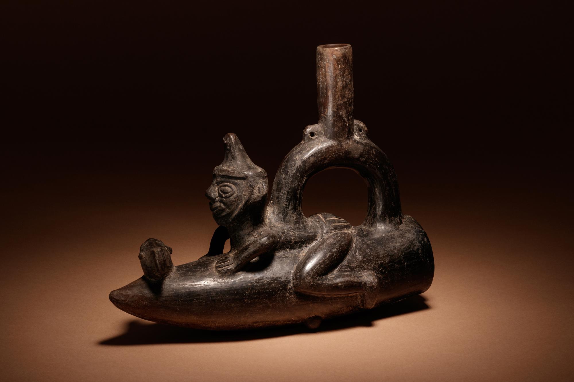 A Moche Stirrup Vessel of Man on Reed Boat with Fish