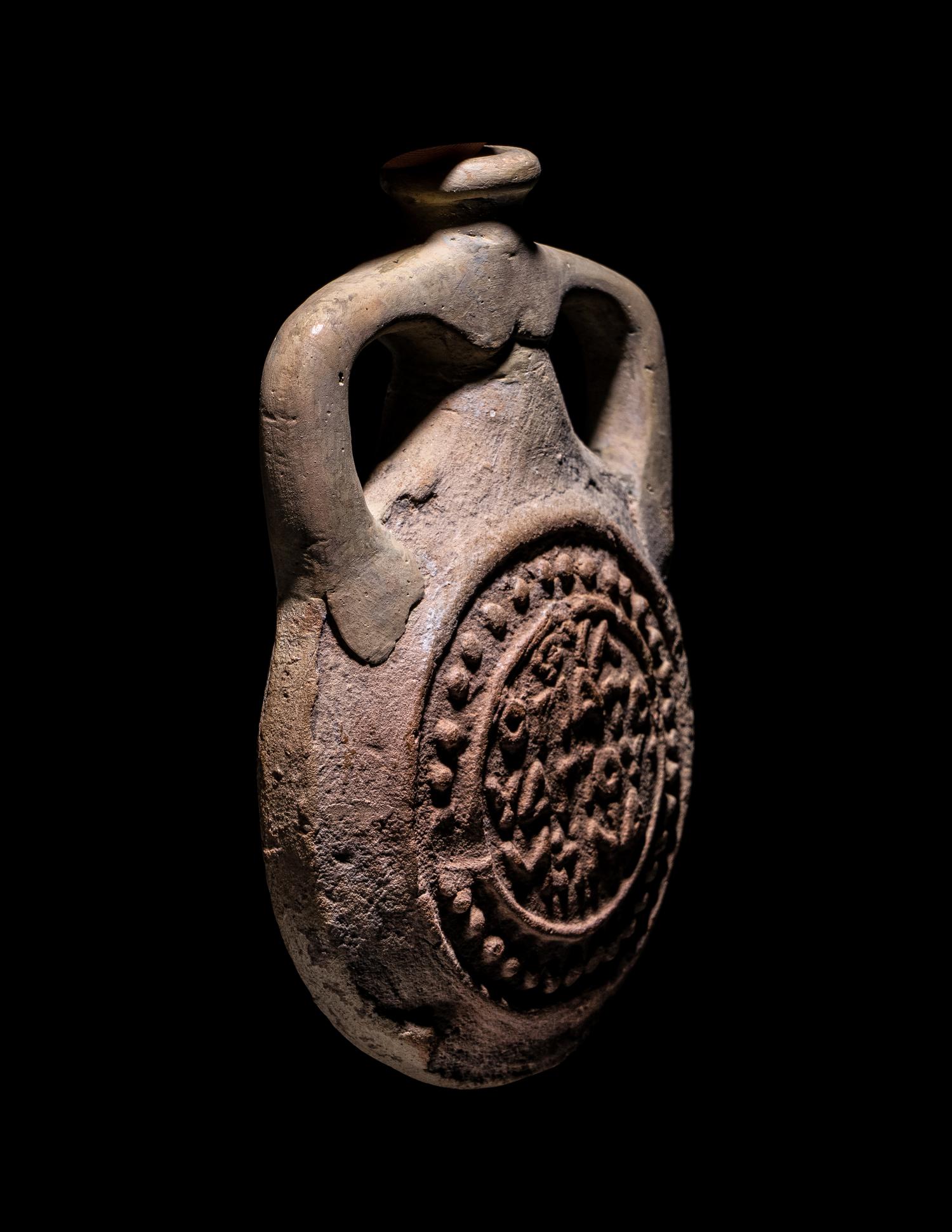 A Coptic Terracotta Pilgrim Flask with Saint Menas and Inscription
