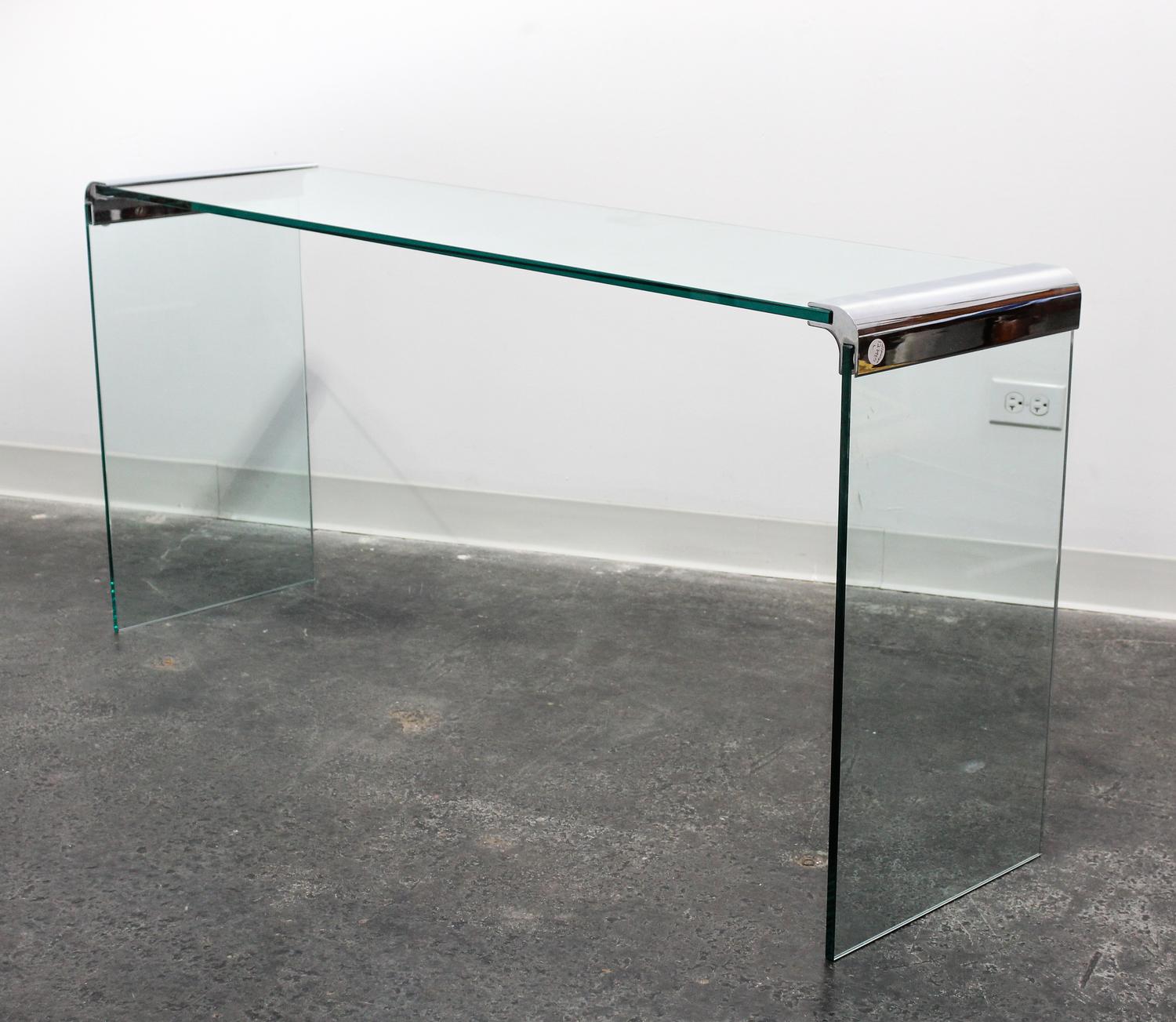 A Chrome and Glass Cocktail Table Length of top 57 inches overall. — 20TH CENTURY