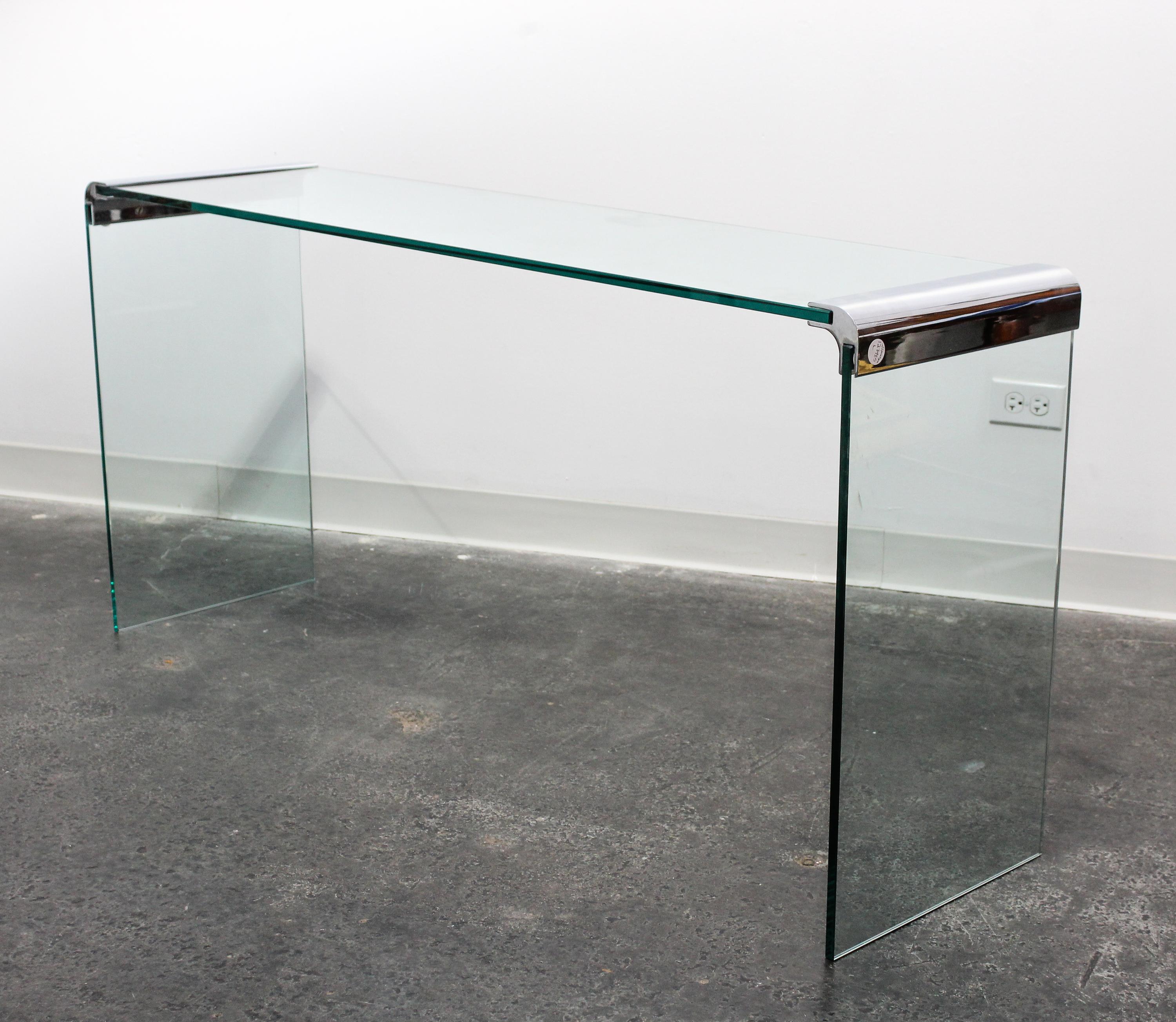 A Chrome and Glass Cocktail Table Length of top 57 inches overall. — 20TH CENTURY