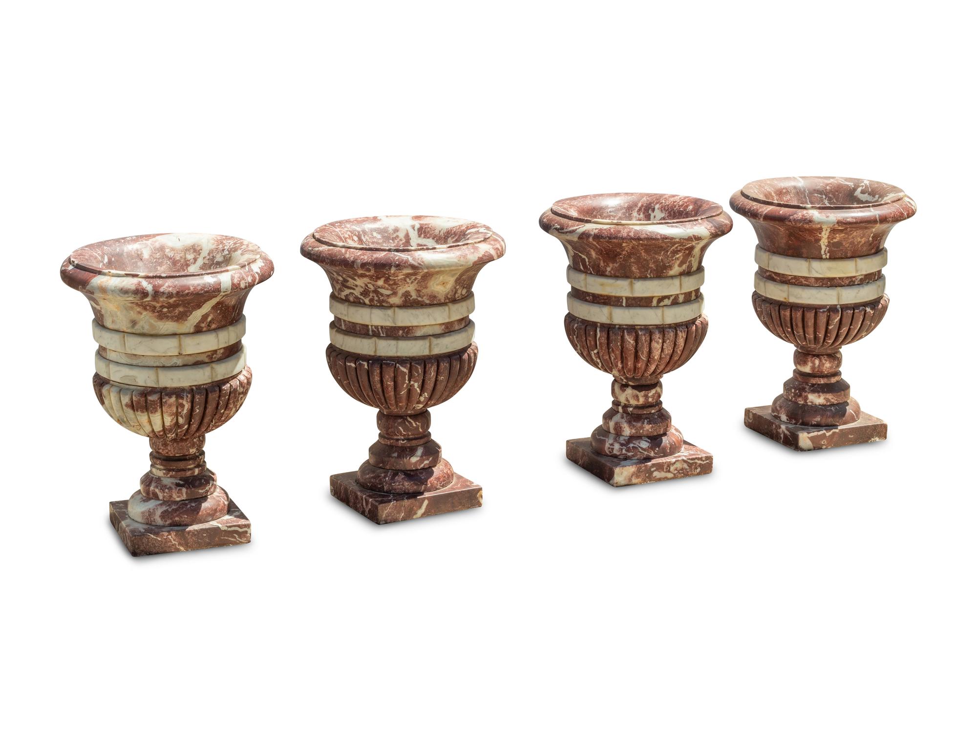 A Set of Four Italian Carved Red and White Marble Urns