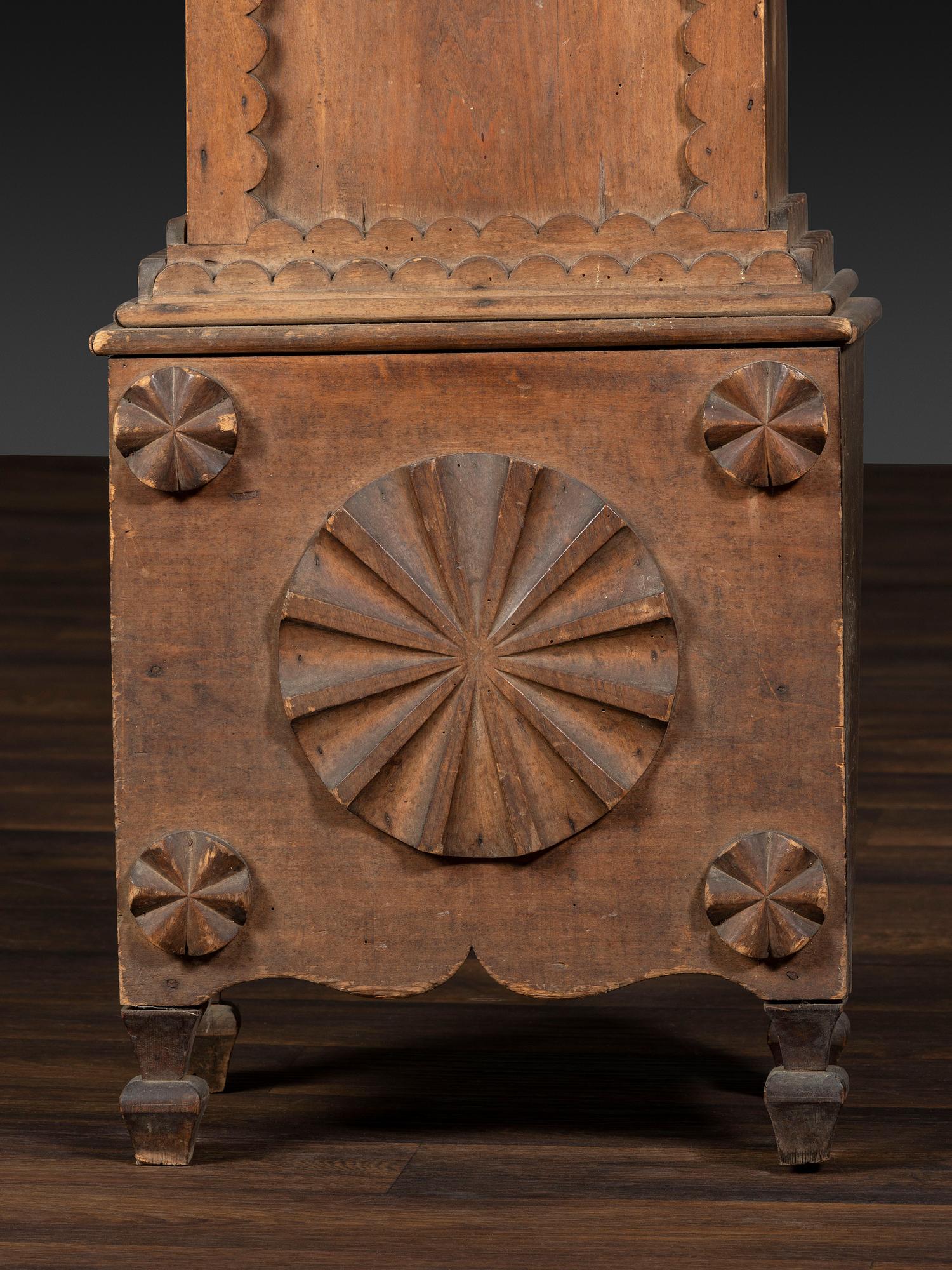 A Folk Art Carved Maple Clock Case