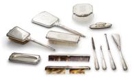 An American Silver Mounted Dresser Set, 20th century, comprising a hand mirror, a glass powder jar with a silver lid, two brushes, two