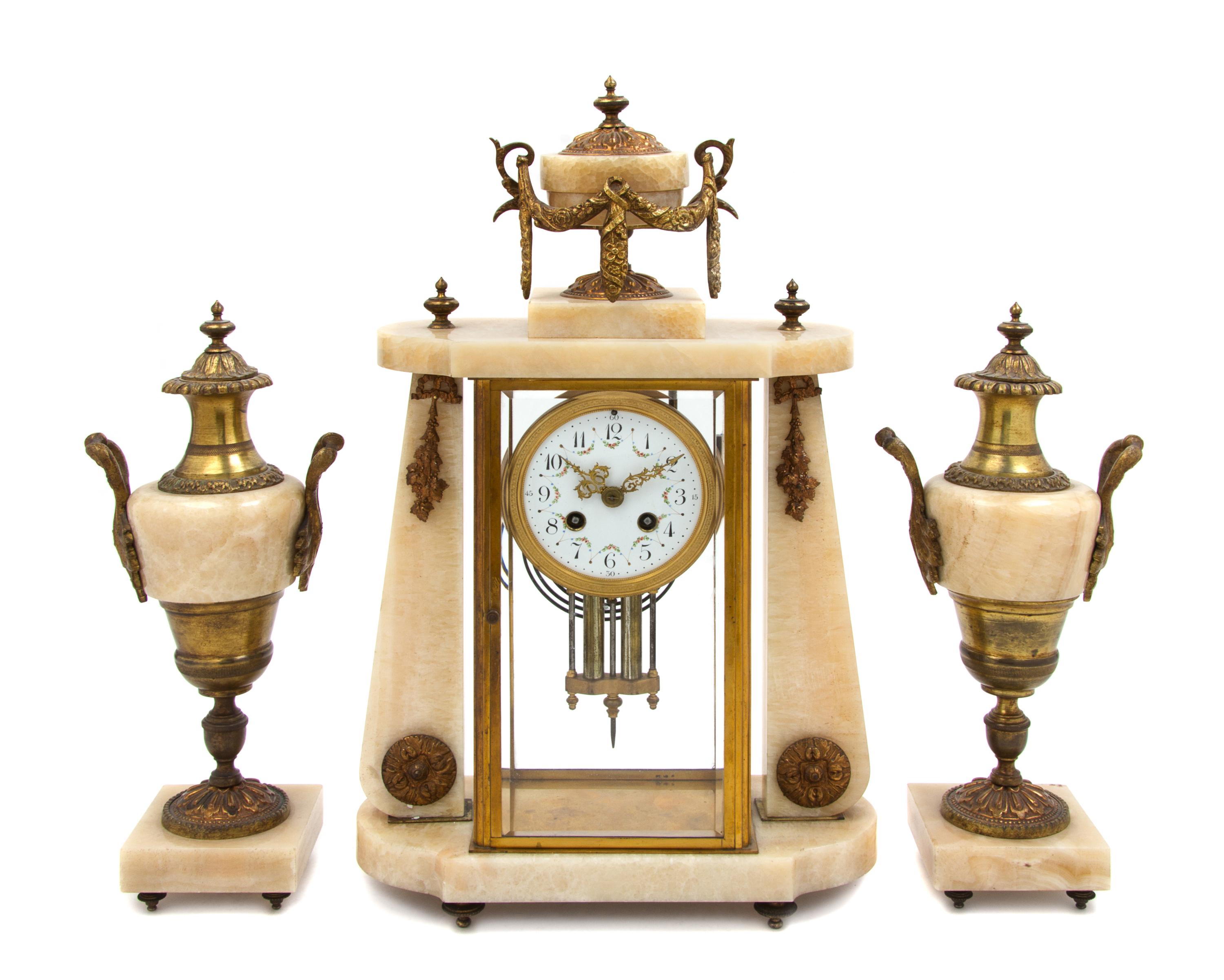 A French Onyx and Gilt Bronze Clock Garniture Height of clock 18 inches. — MOVEMENT BY FRITZ MARTI