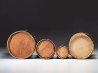 Four Painted Wood Firkins and a Wooden Butter Churn