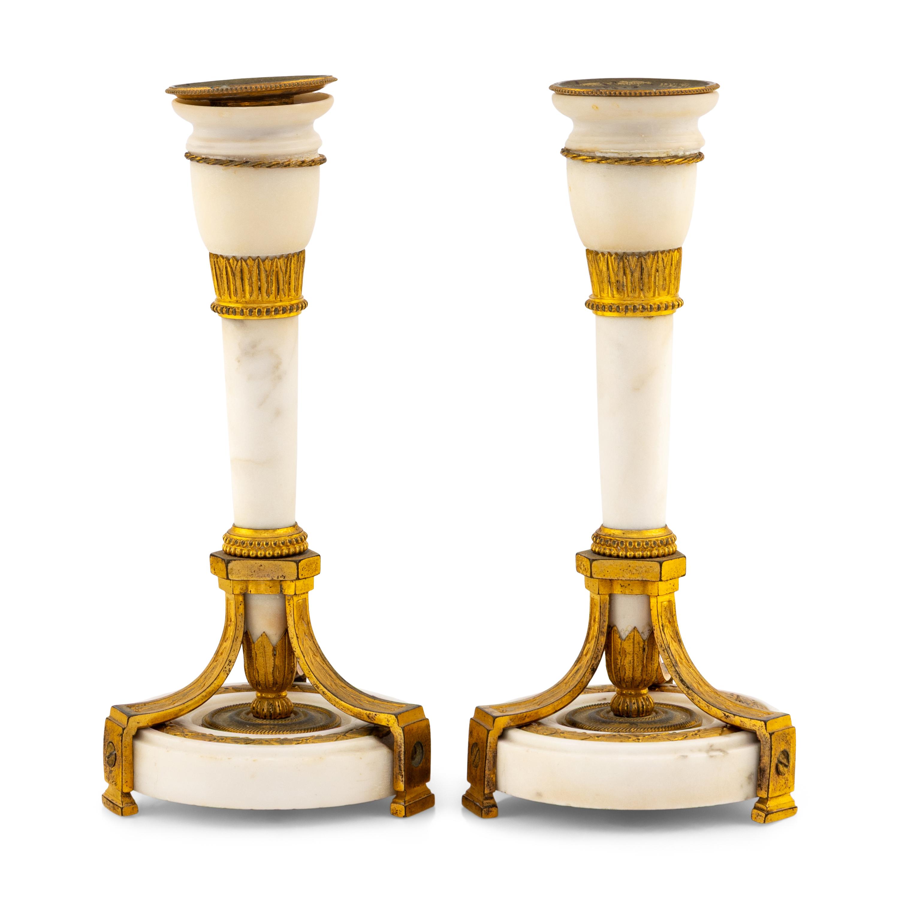 A Pair of Directoire Gilt Bronze and White Marble Candlesticks