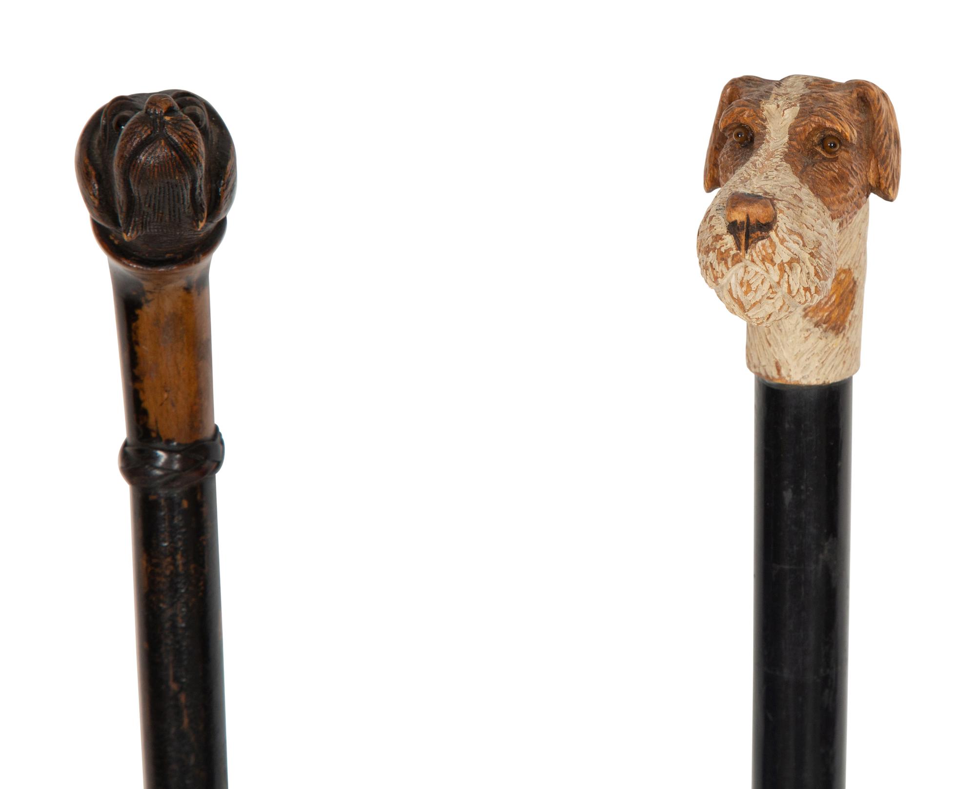 Two Ebonized Walking Sticks with Zoomorphic Handles