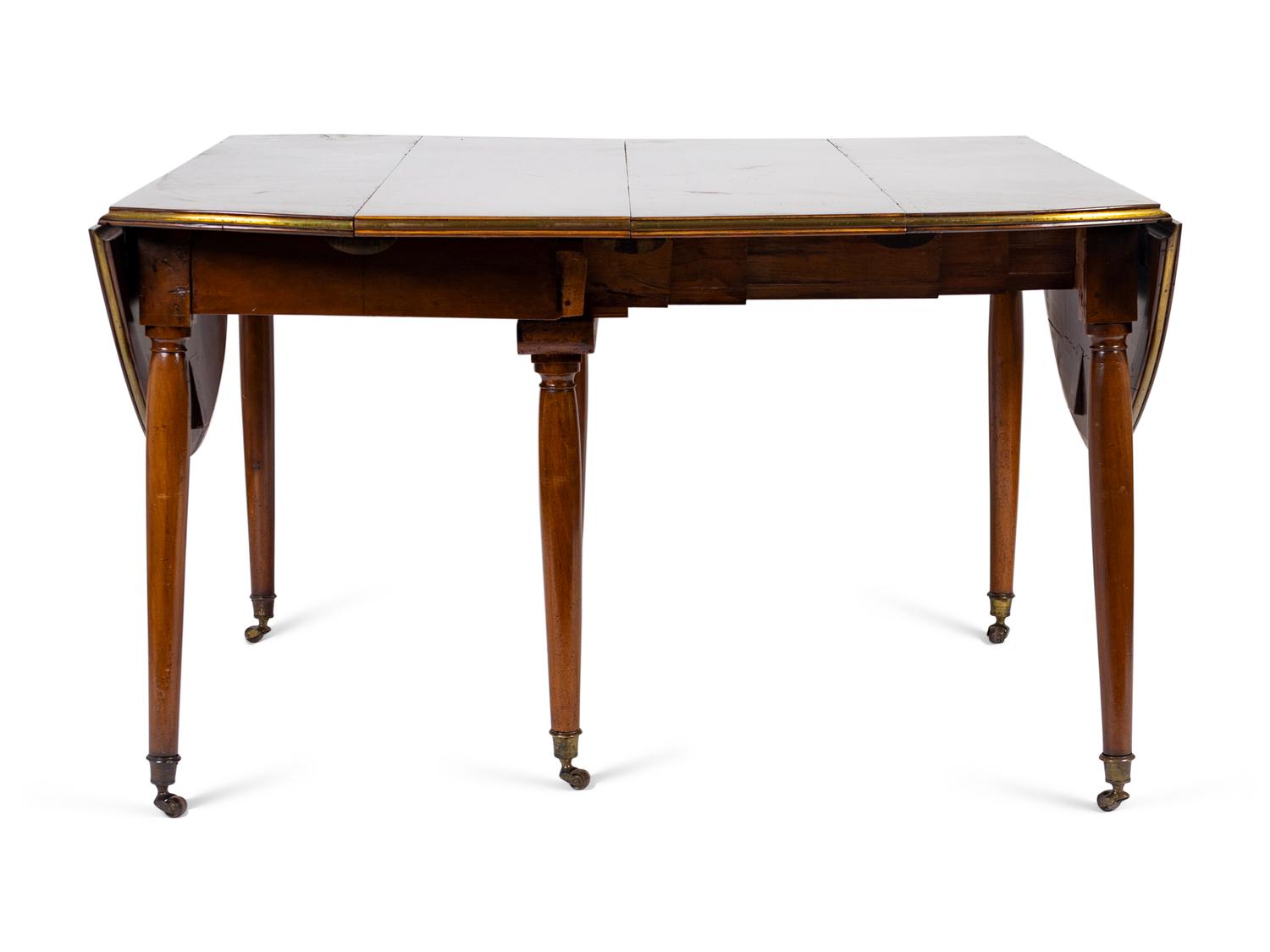 A Louis XVI Mahogany and Brass Banded Extension Dining Table — CIRCA 1790