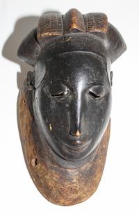 A Yaure Painted Wood Mask. Height 12 inches.