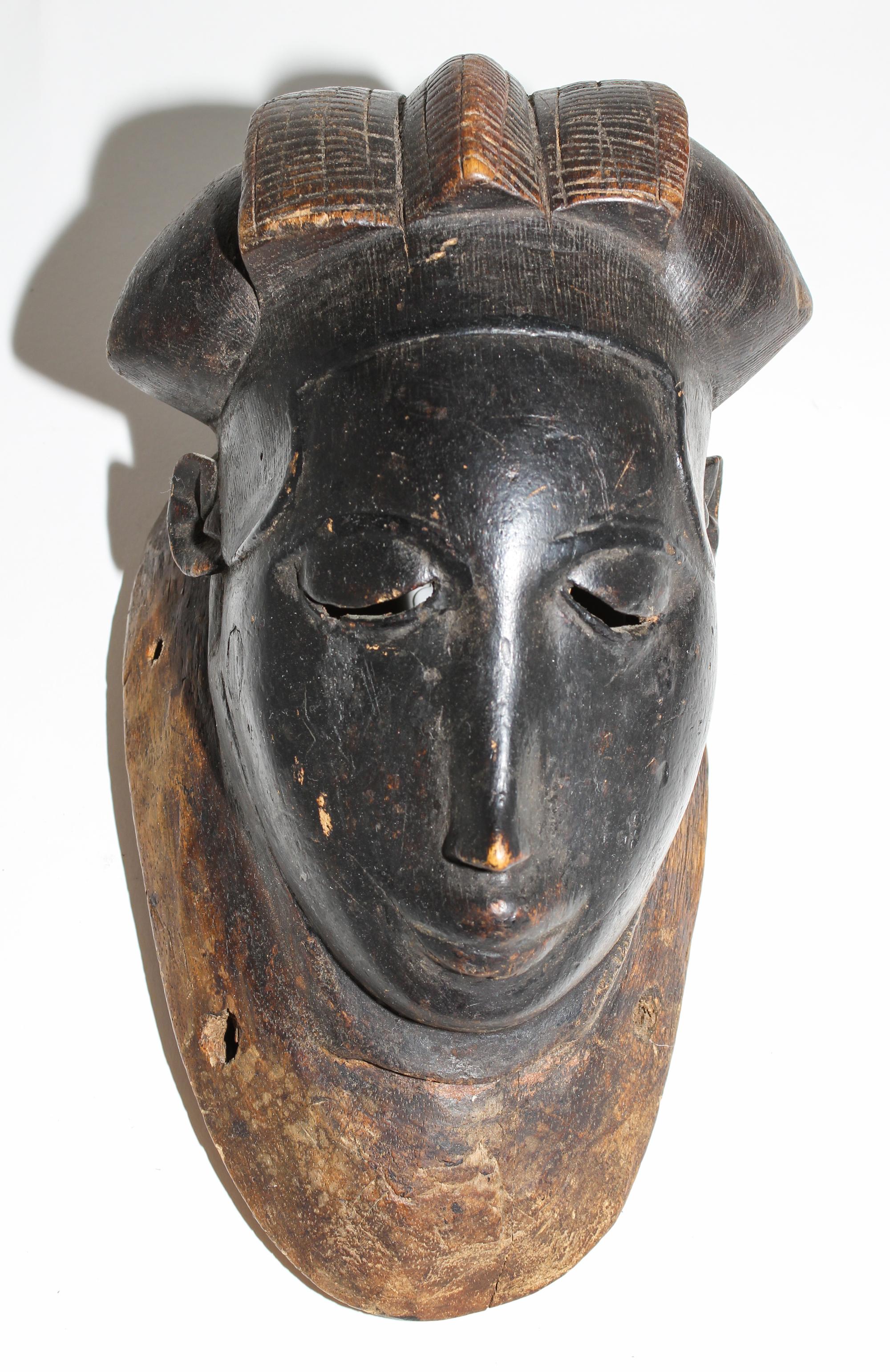 A Yaure Painted Wood Mask. Height 12 inches.