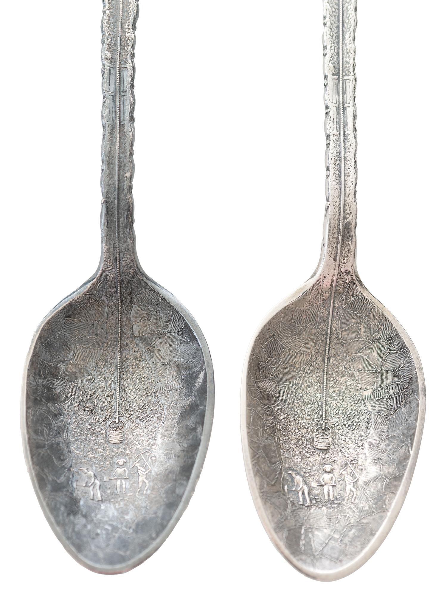 [WESTERN AMERICANA]. A group of 2 Henry Bohm silver banquet spoons commissioned by railroad magnate Otto Mears and featuring detailed mining scenes, ca 1890s.