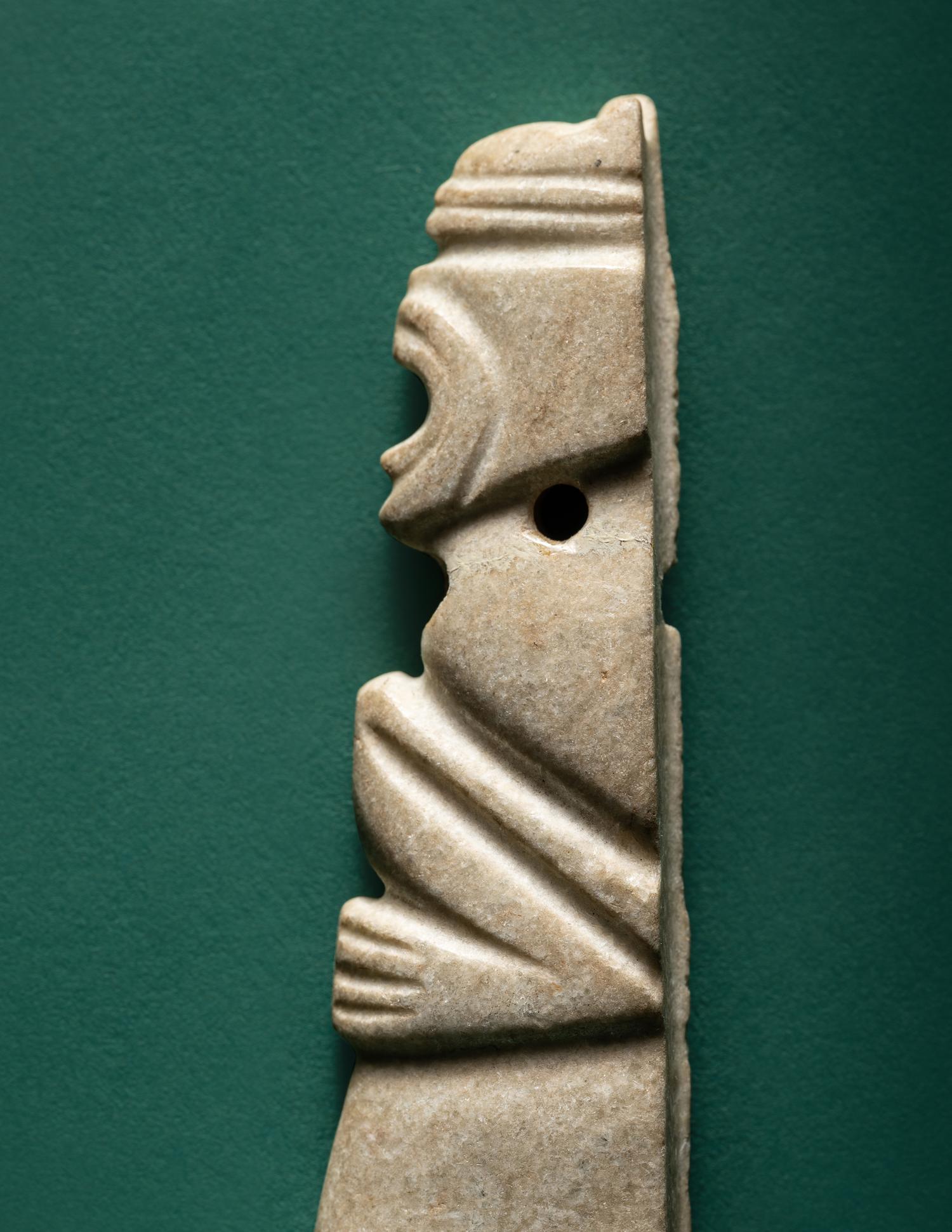 A Costa Rican White Jade Axe Pendant of a Crouching Monkey