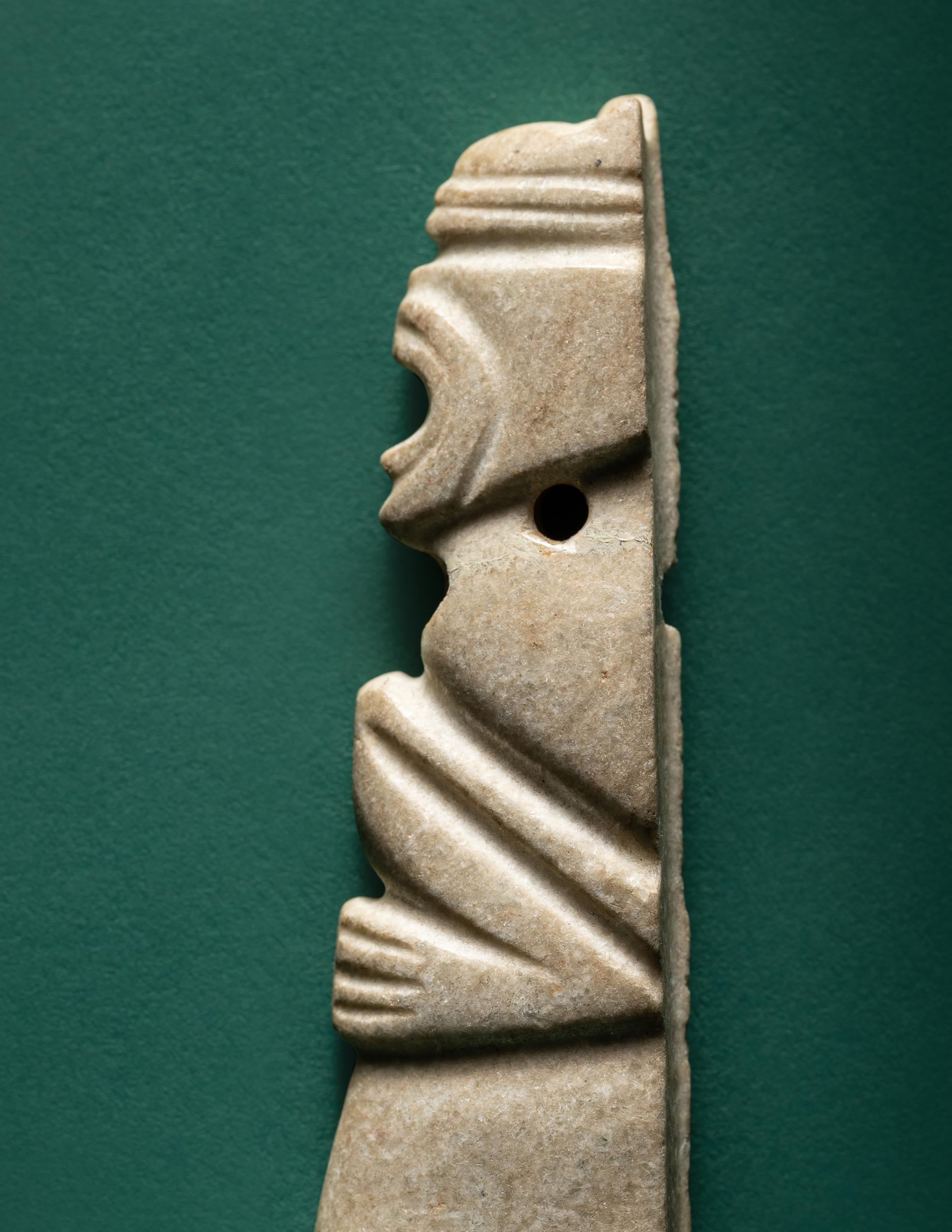 A Costa Rican White Jade Axe Pendant of a Crouching Monkey